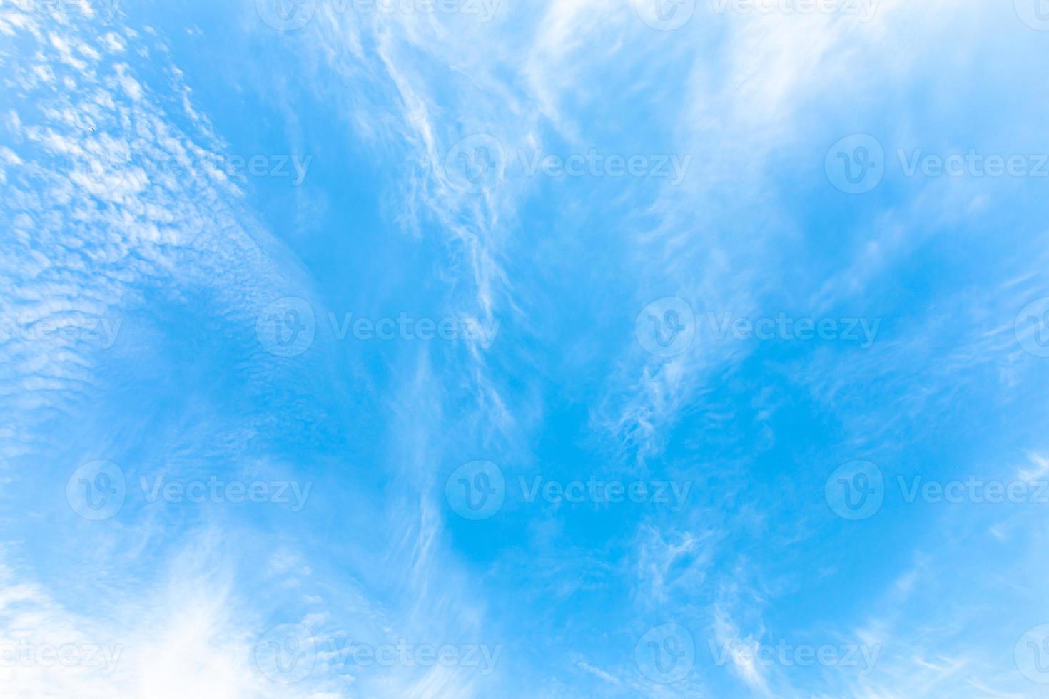 Beautiful white abstract cirrus clouds as if they diverging away from the center on blue sky. photo