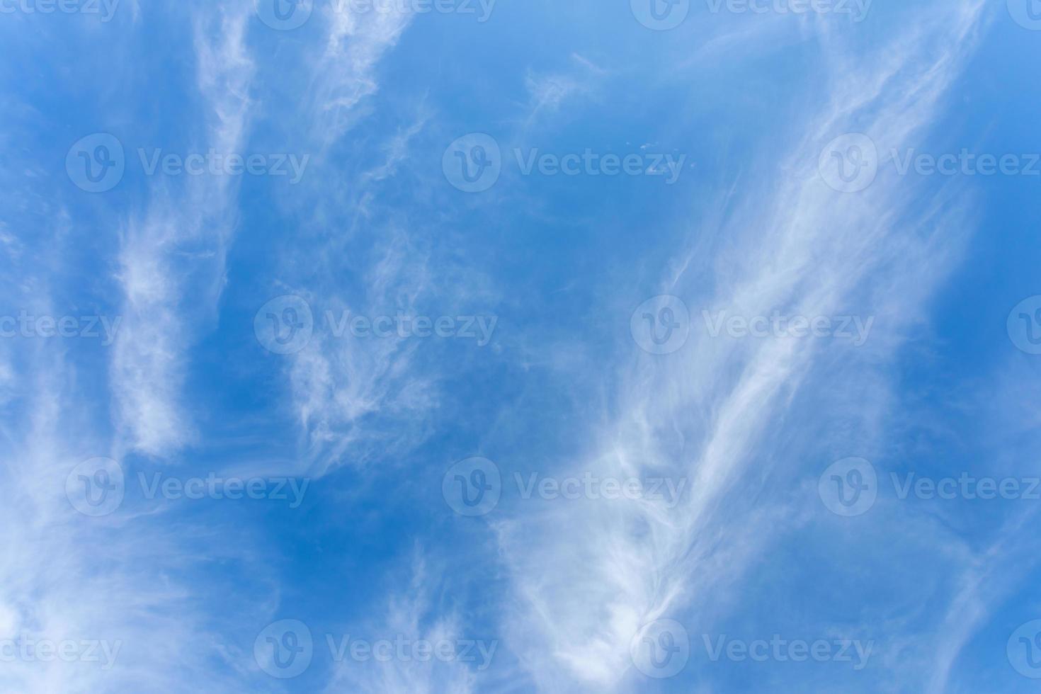 Wonderful pattern of white cirrus clouds in summer sky close up. Sky background or wallpapers. photo