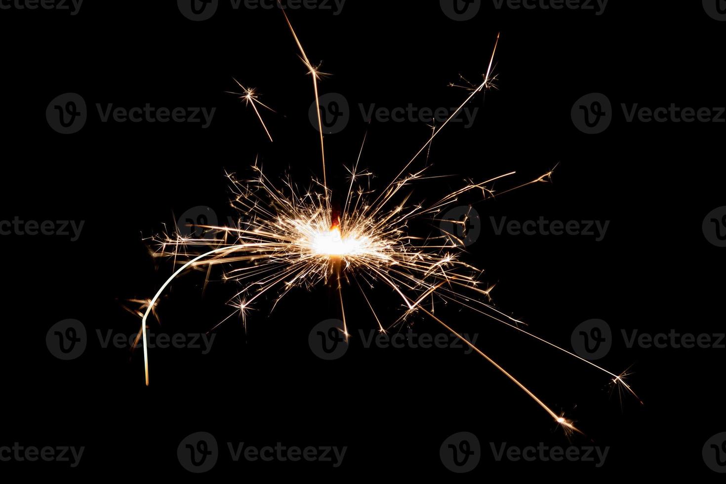 Burning sparkler isolated on black background. Fireworks theme. Light effect and texture. photo