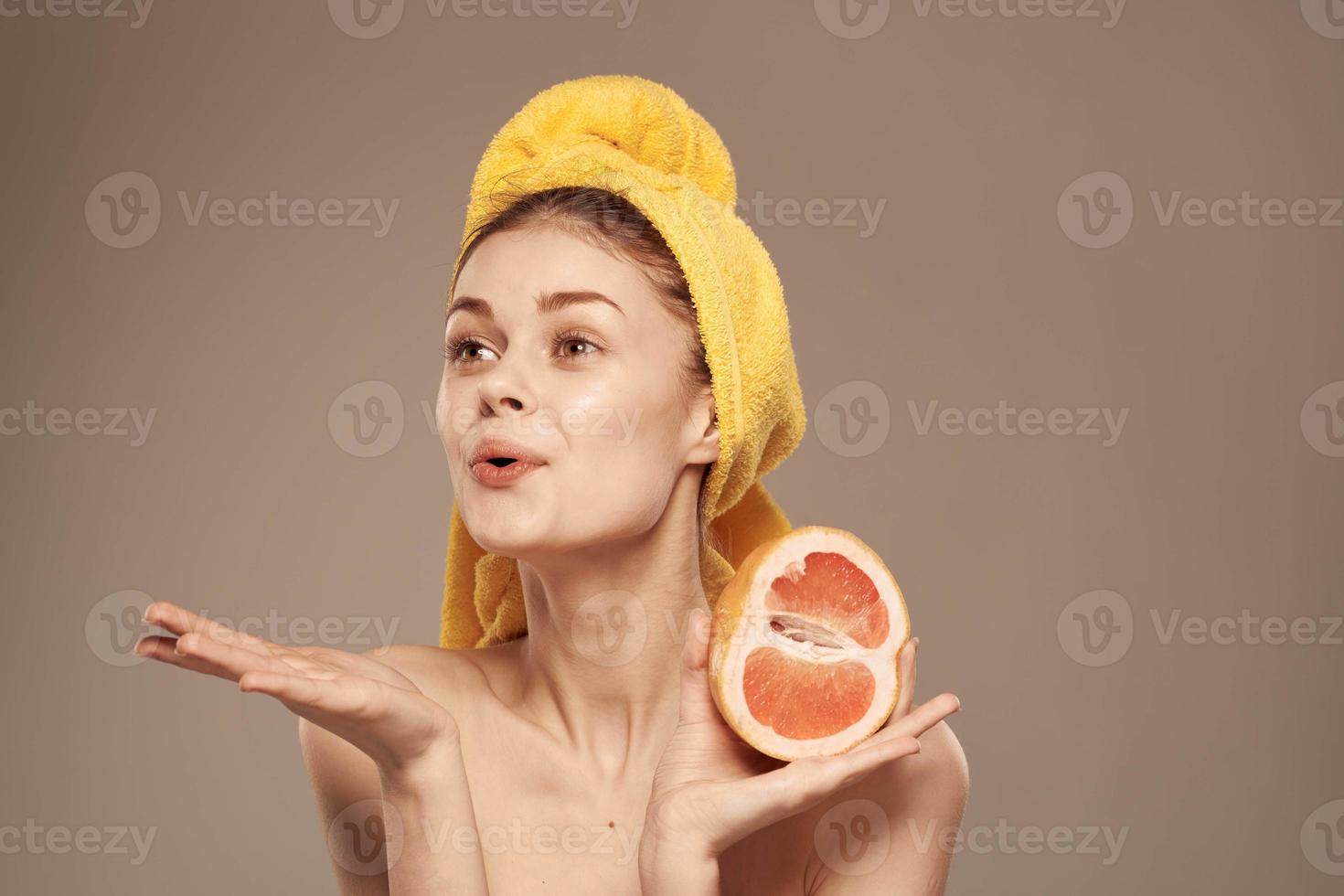 Woman with a towel on her head grapefruit in her hands health vitamins bared shoulders photo