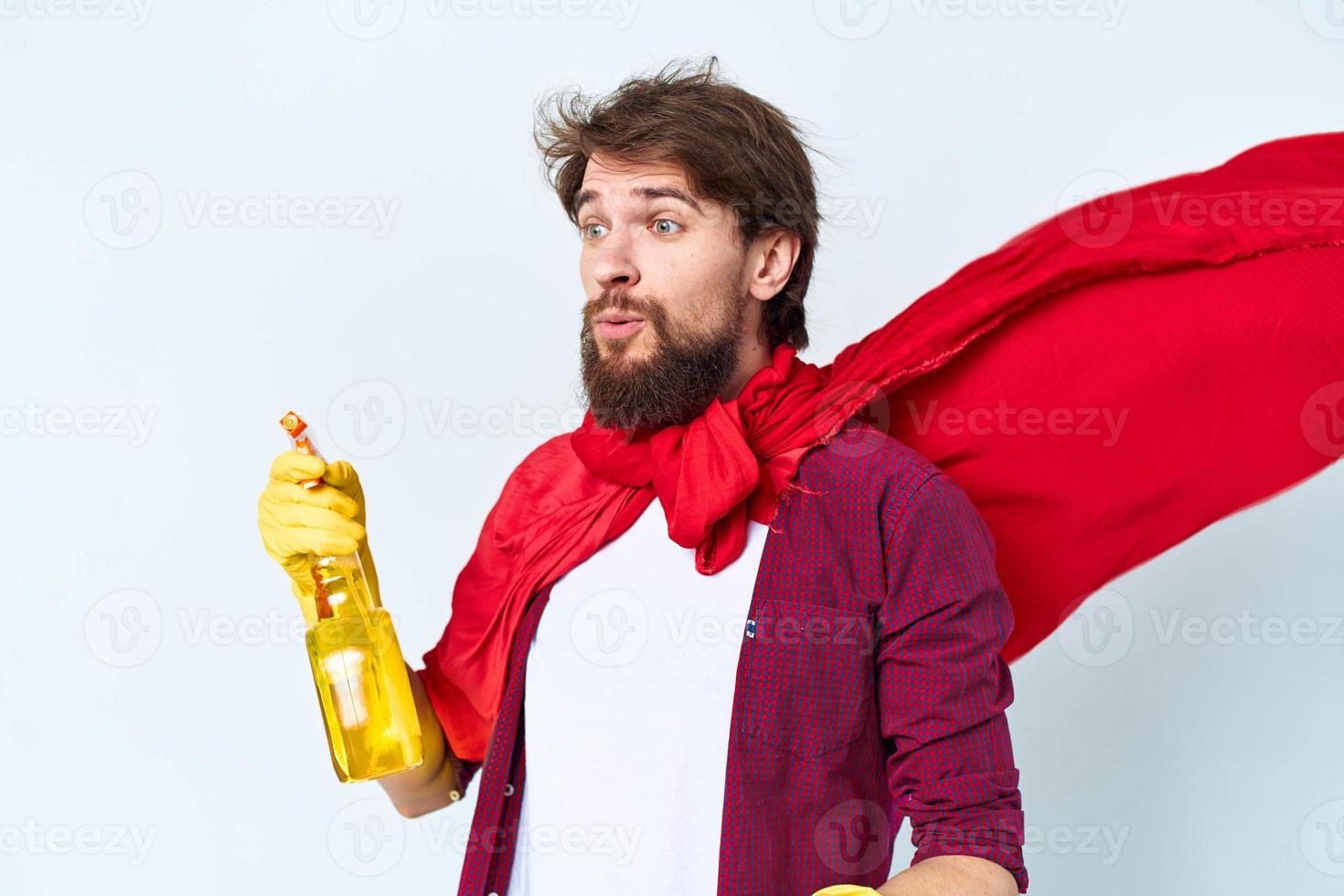 Man with detergent cleaning professional red raincoat cropped view of housework photo