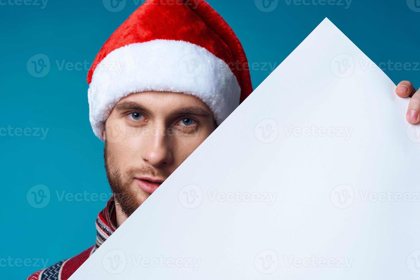 Cheerful man in a santa hat holding a banner holiday isolated background photo
