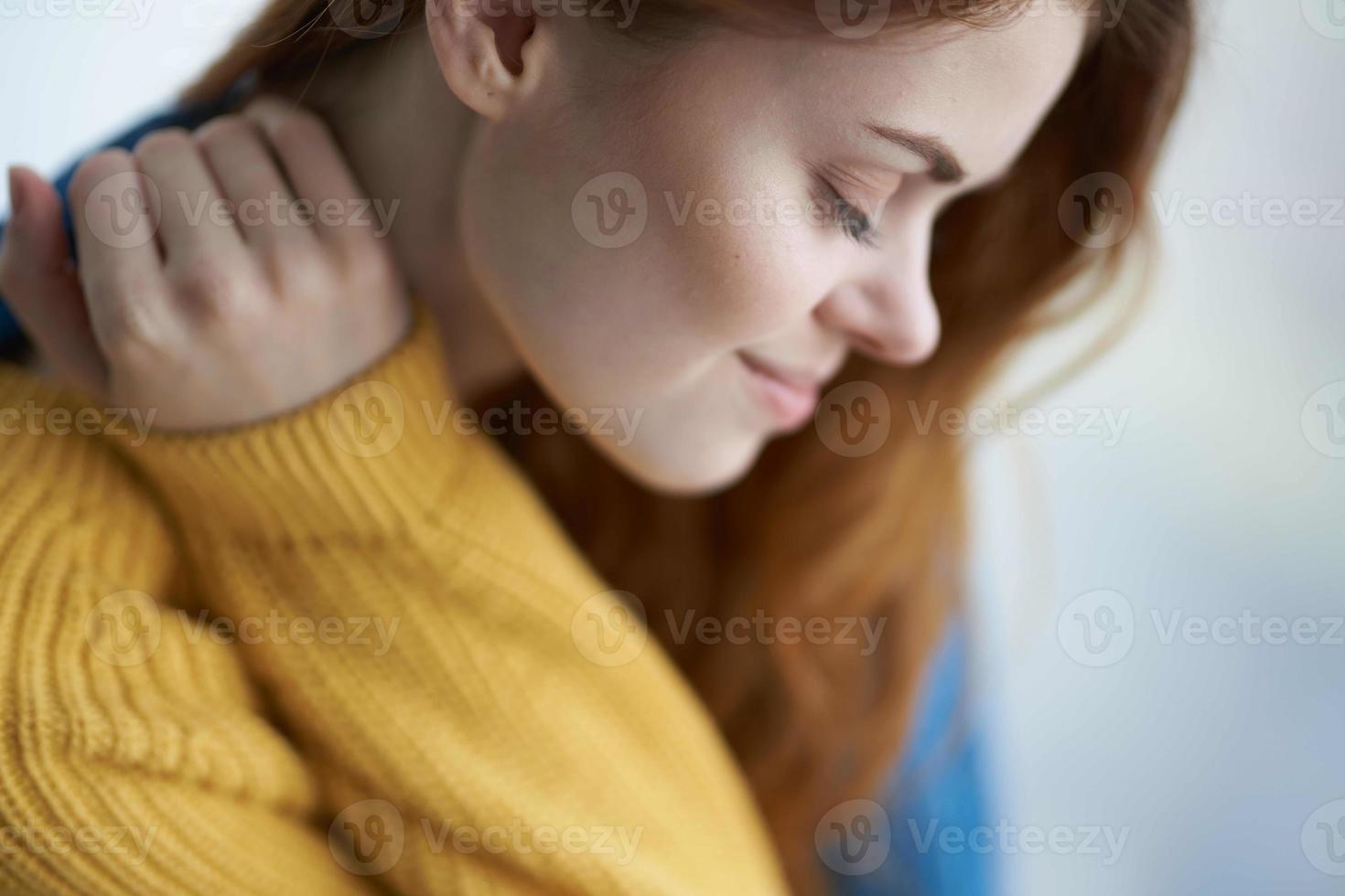 woman sitting on the windowsill with a blue plaid morning photo