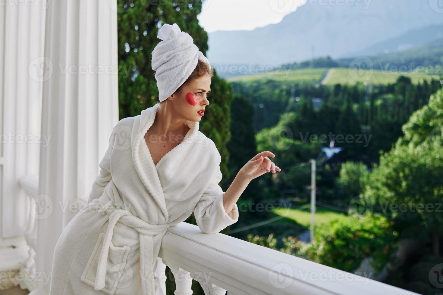 a fit girl having beauty under-eye patch treatment looking on the view photo