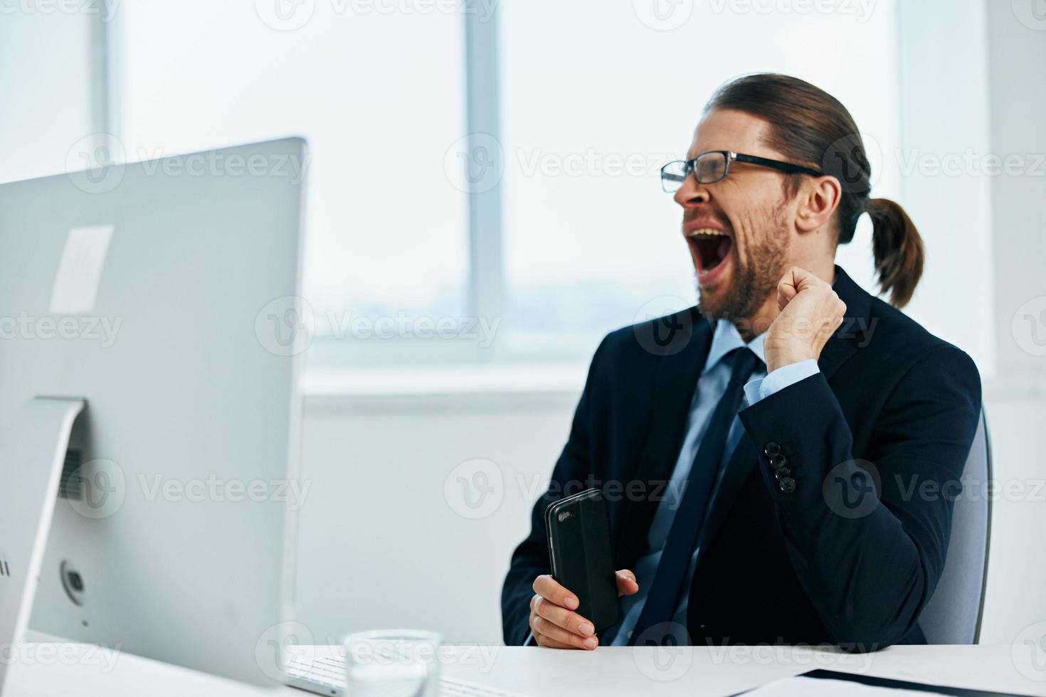 office worker work in front of a computer documents Chief photo