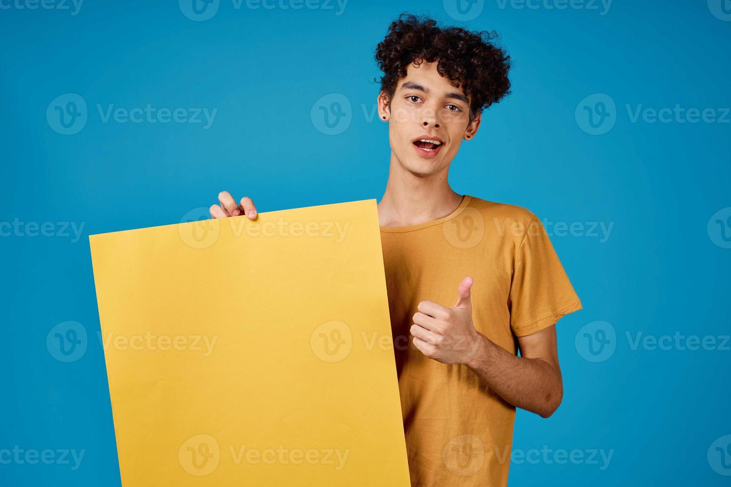 curly guy with yellow mockup poster blue background photo