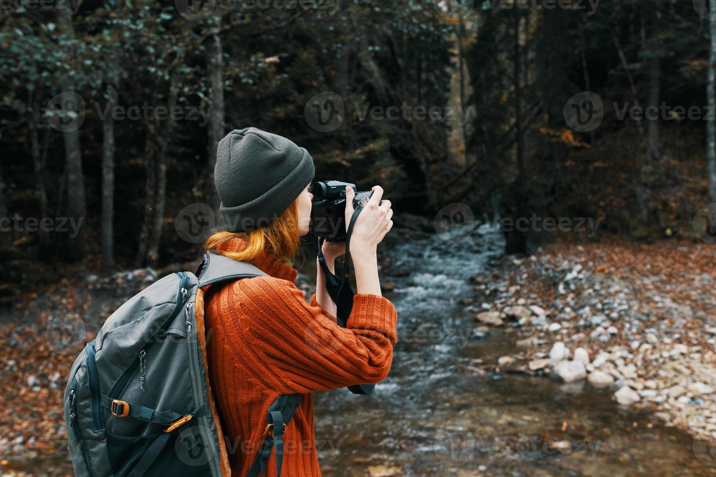 woman tourist photographing nature river forest mountains photo
