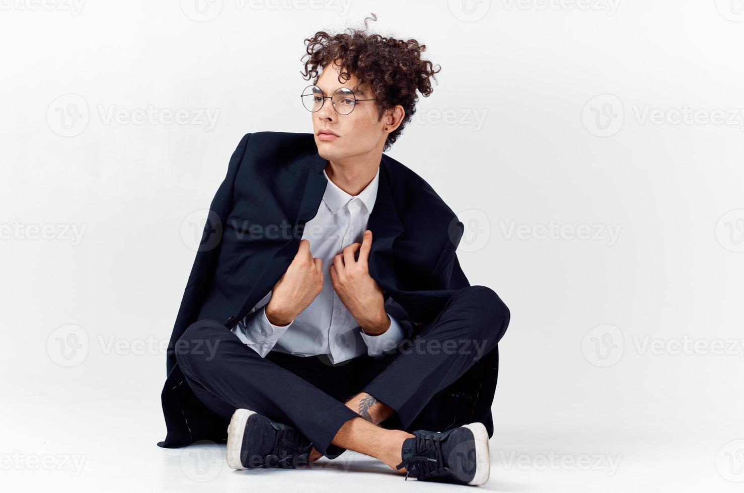Cheerful guy in a classic suit with a jacket on his shoulders and gesturing with his hands Copy Space sneakers photo