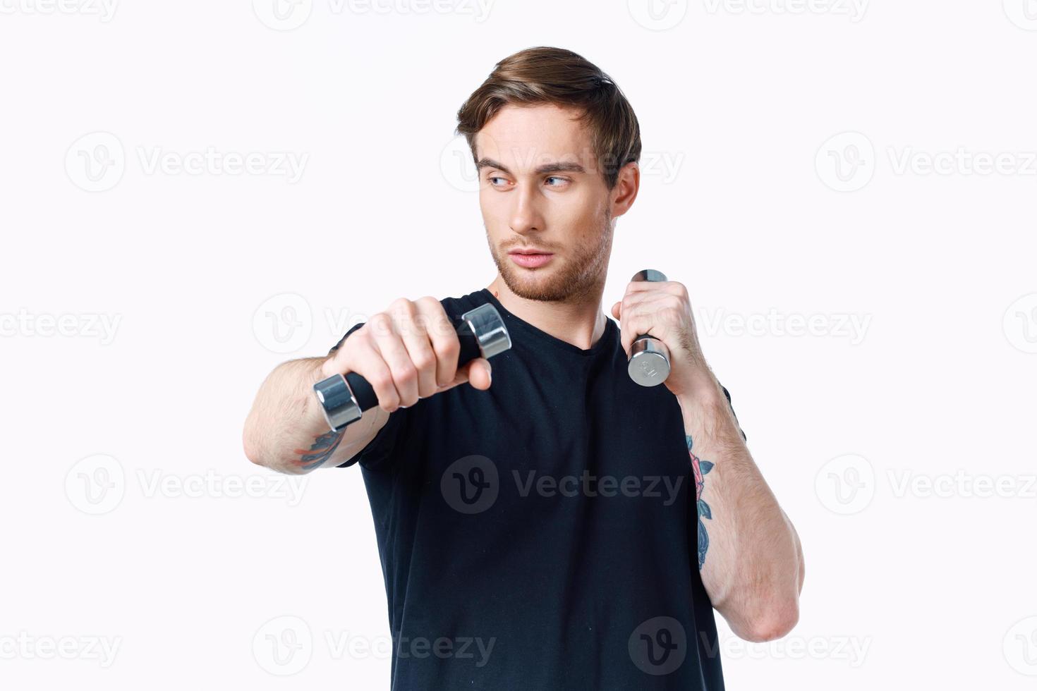 chico en un negro camiseta con pesas en su mano en un blanco antecedentes Copiar espacio foto