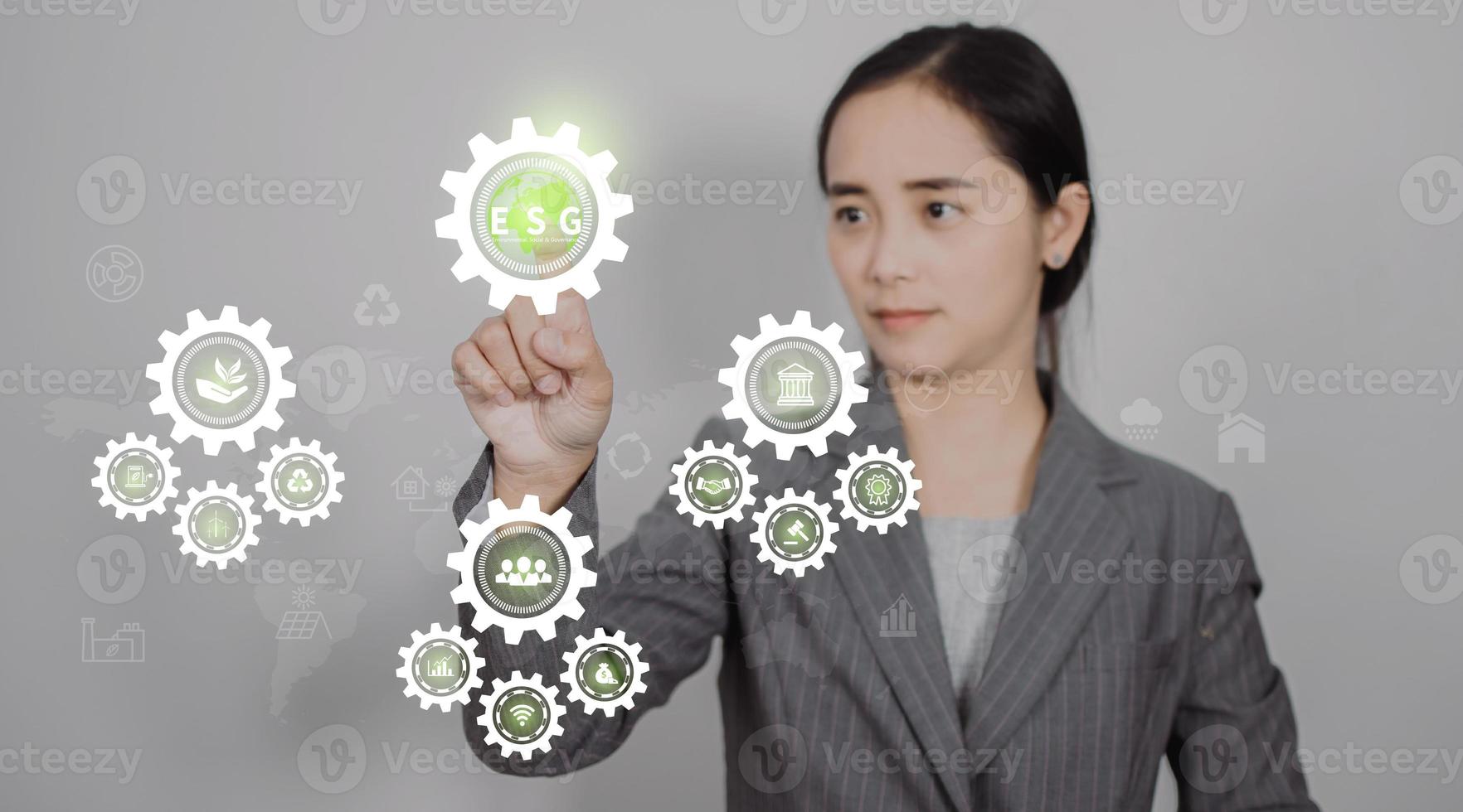 Hand touching ESG icon on virtual screen for environmental, social, and governance in sustainable and ethical business on a green background photo