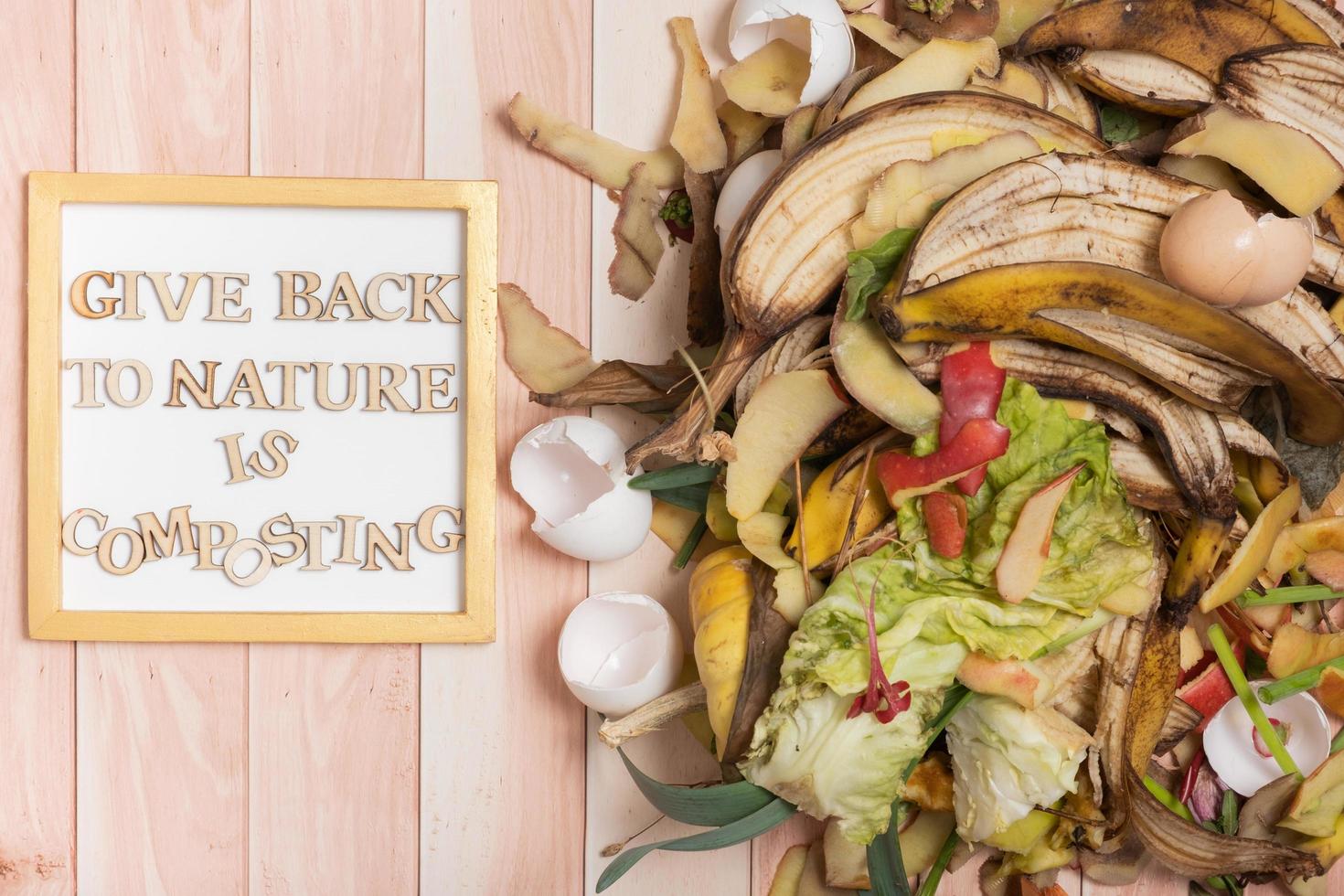 Give back to nature is composting motivation text with organic garbage for compost photo