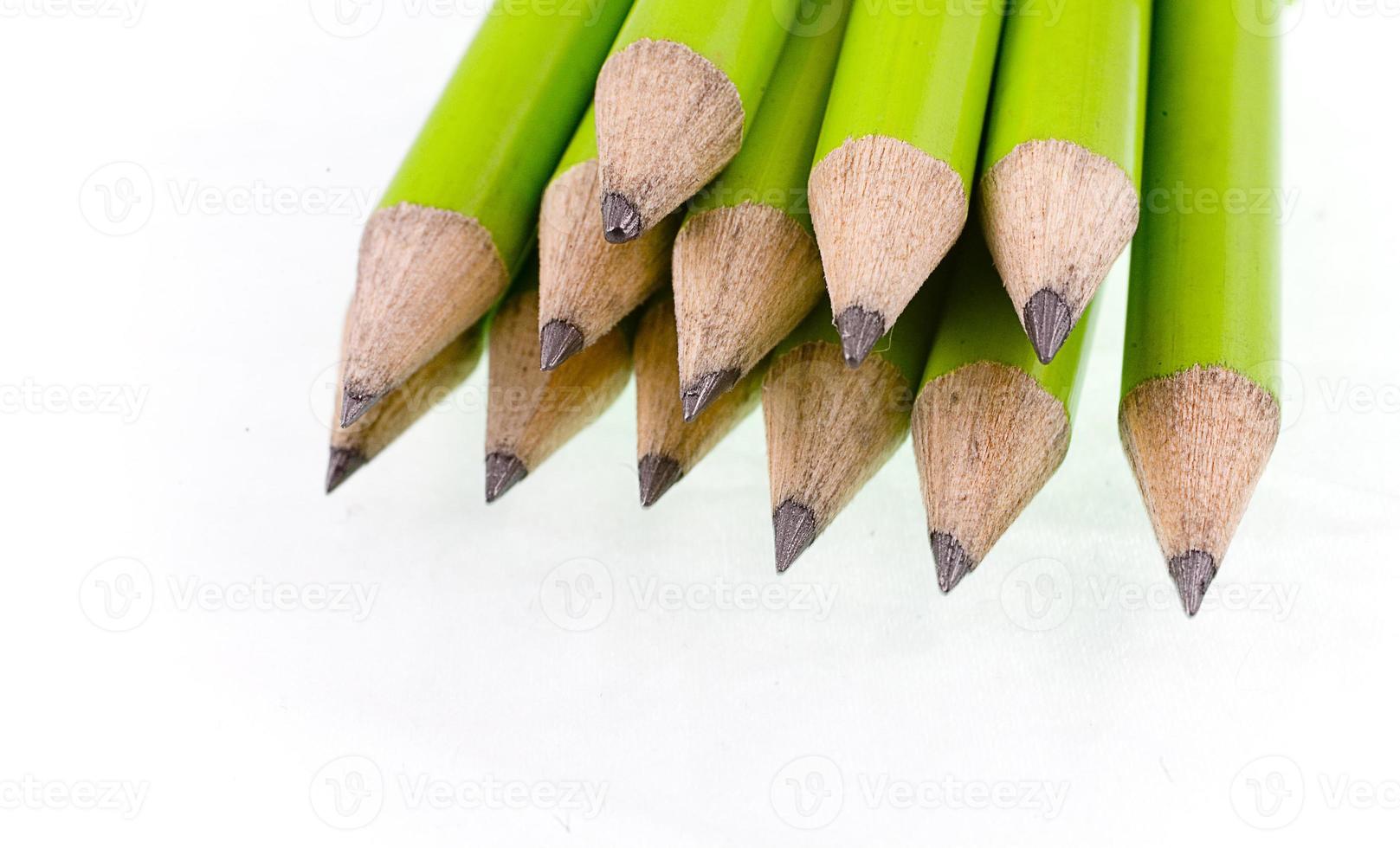 green prepared pencils on white isolated background photo