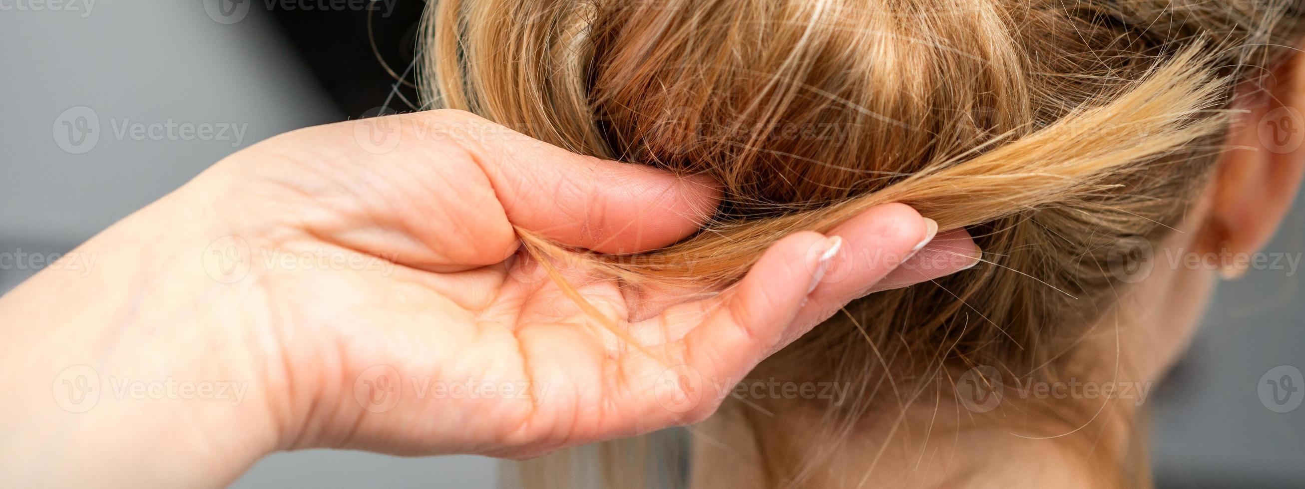 Hairdresser styling hair of woman photo