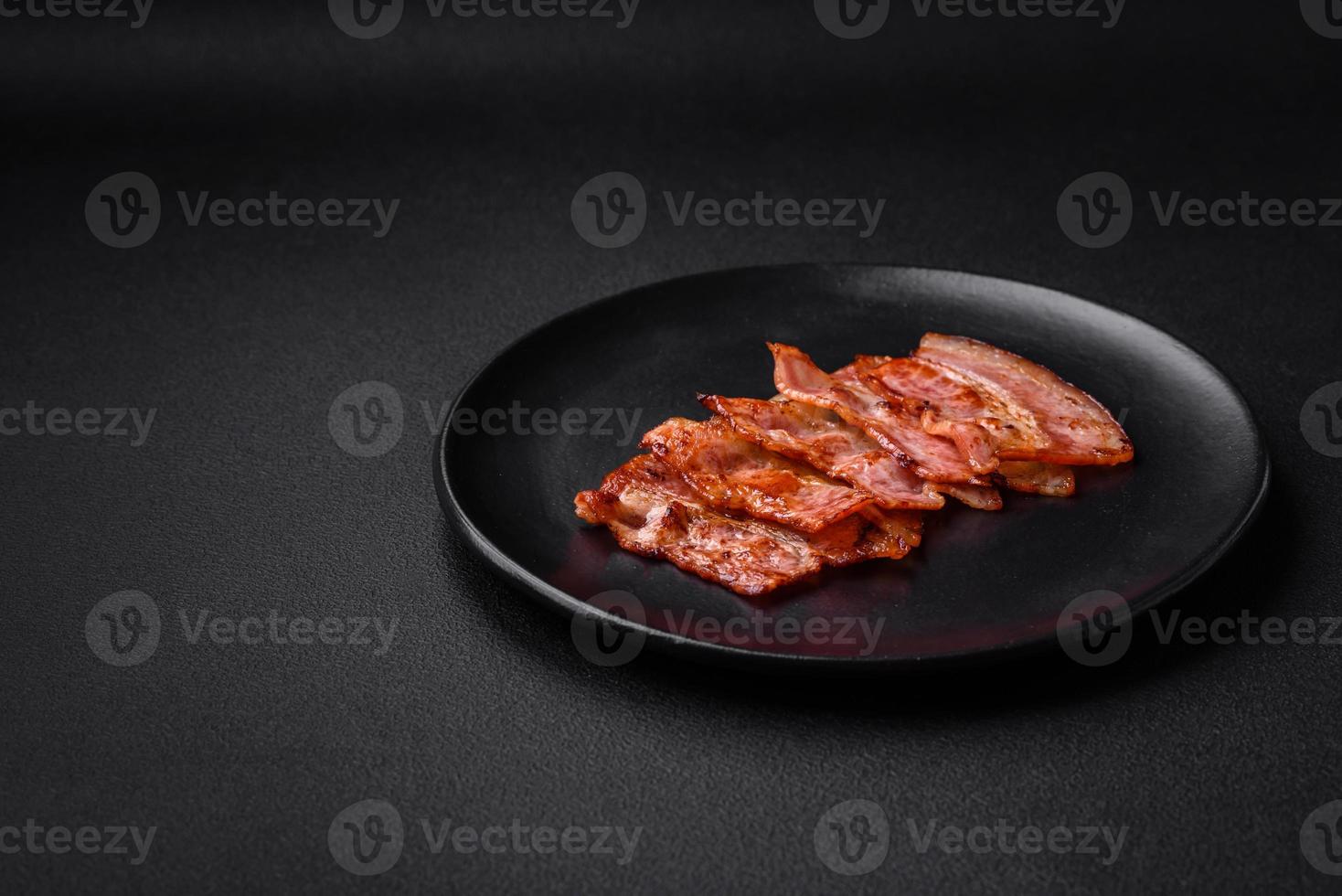 Delicious fresh fried bacon stripes with spices photo