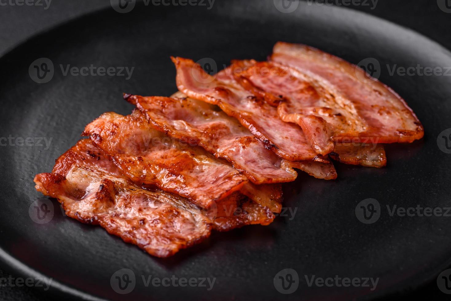 Delicious fresh fried bacon stripes with spices photo