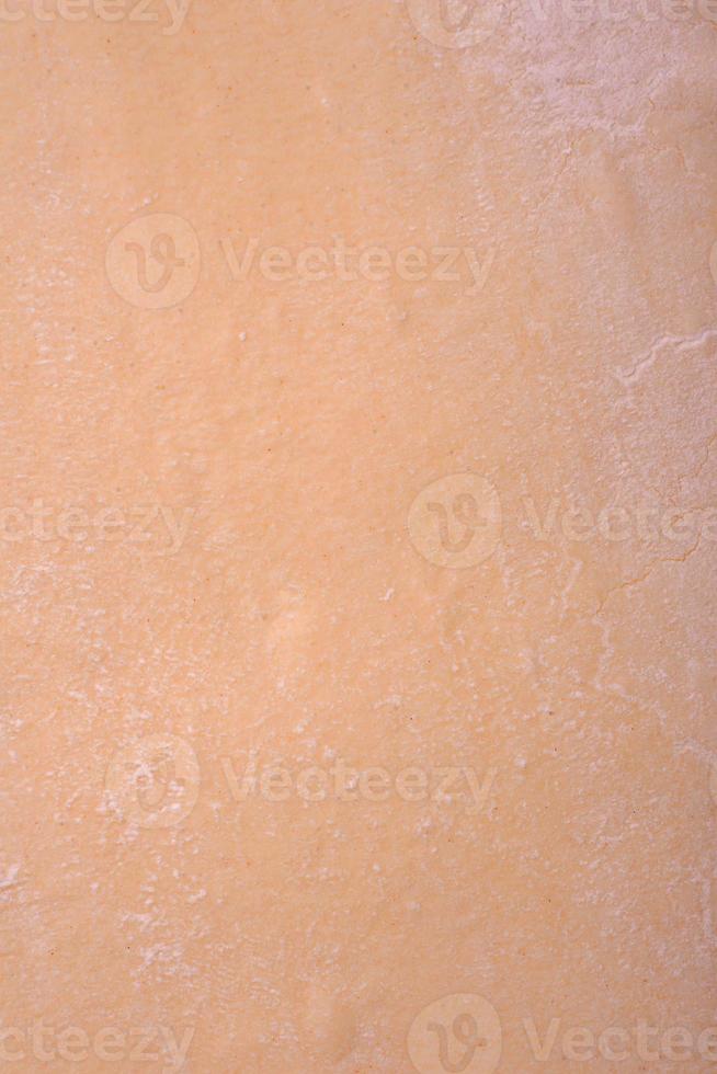 Sheets of raw puff pastry on a dark concrete background photo