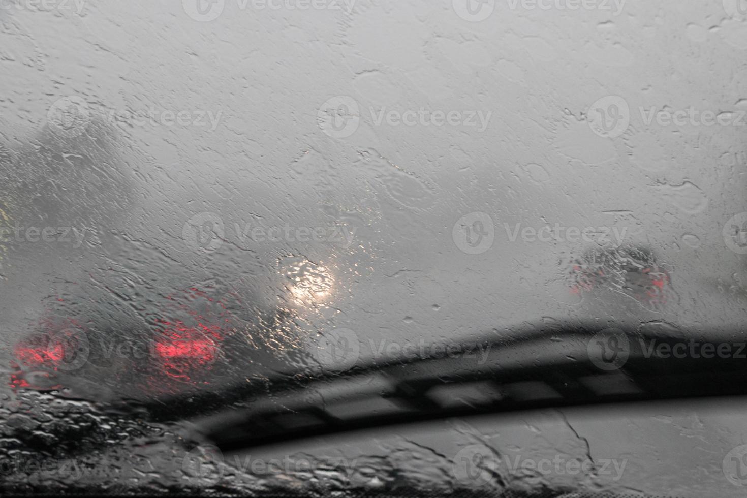 view through the car window of traffic in the rain photo