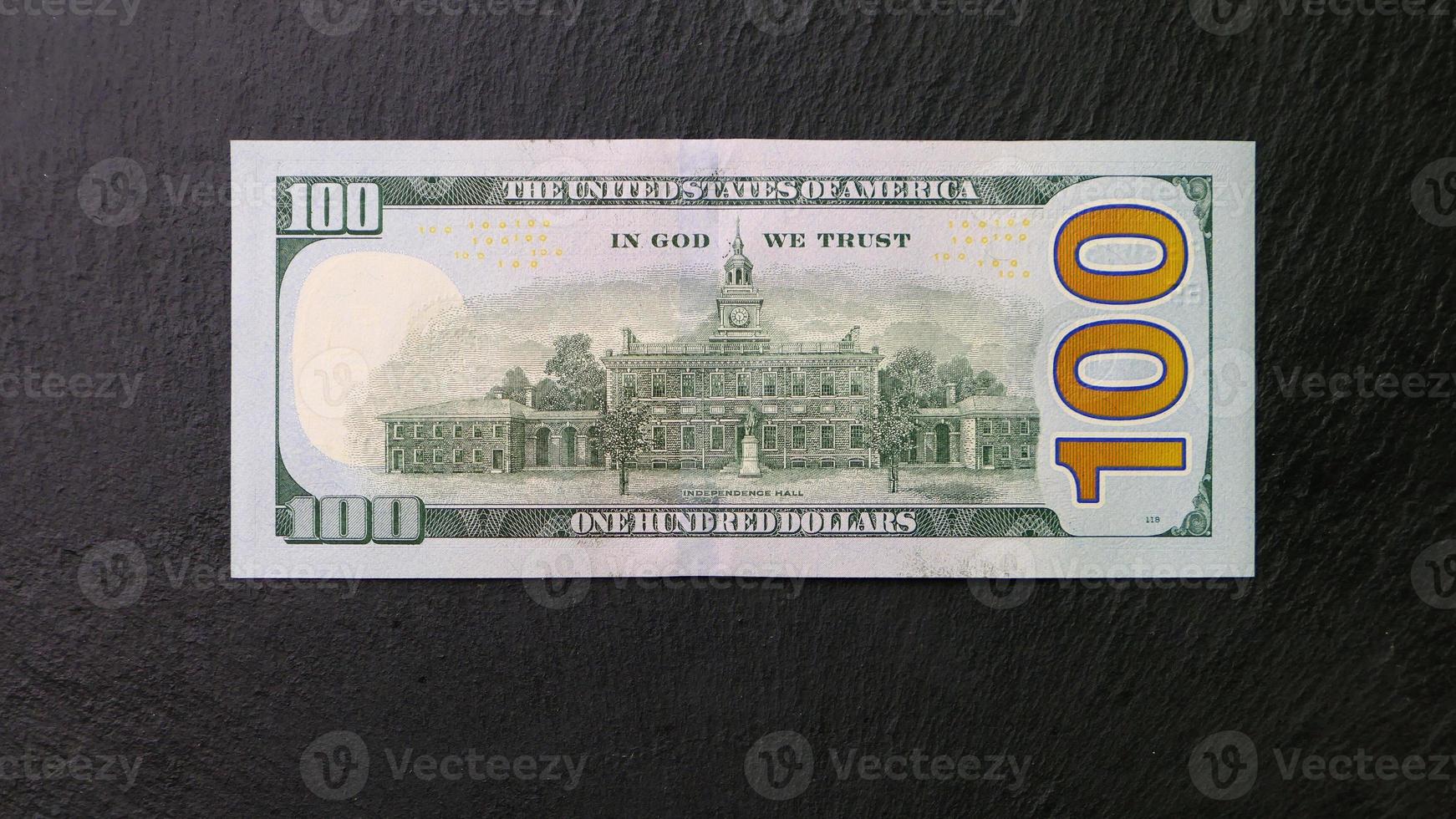 One hundred dollar bill on a black plate Back view Financial concept photo