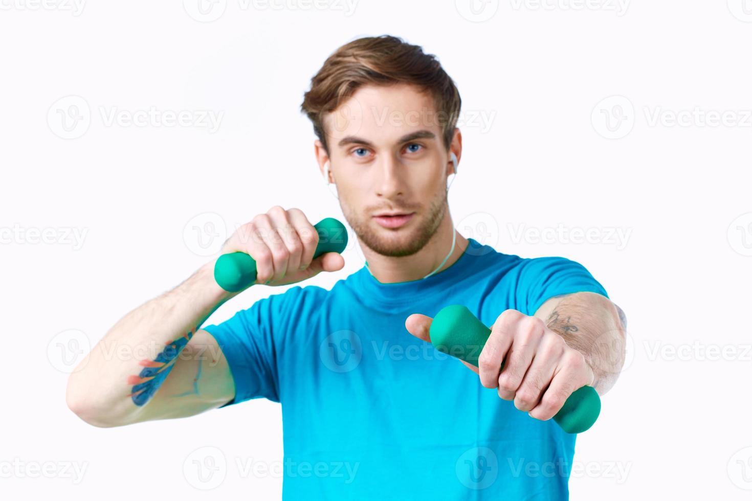 hombre en azul camiseta desde pesas en manos aptitud foto