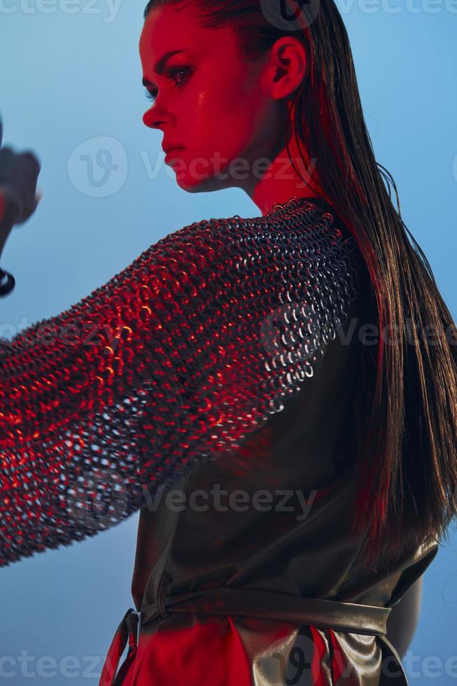 attractive woman in dress arm in armor chain mail protection isolated background photo