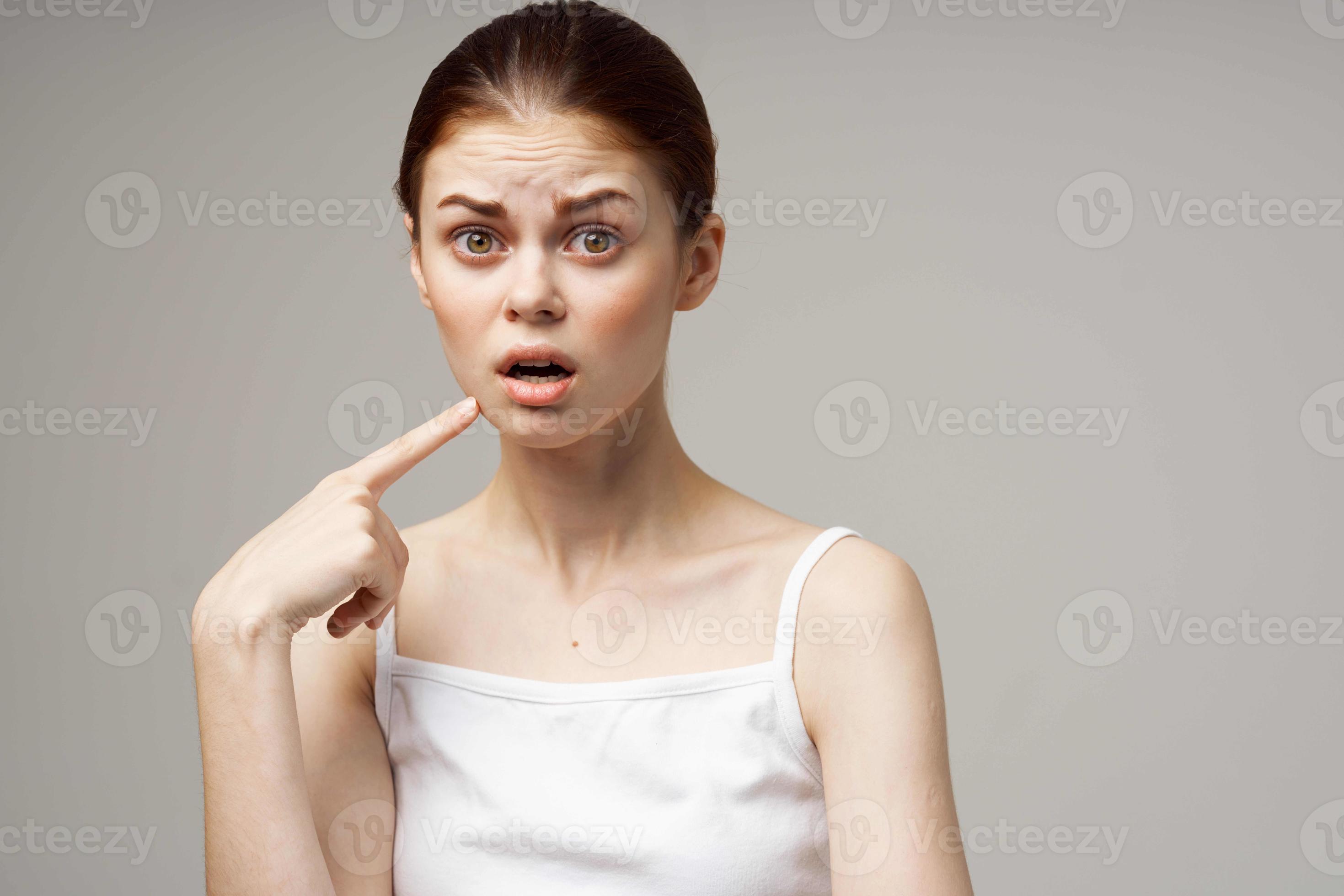 disgruntled woman holding on to face pain in teeth isolated background