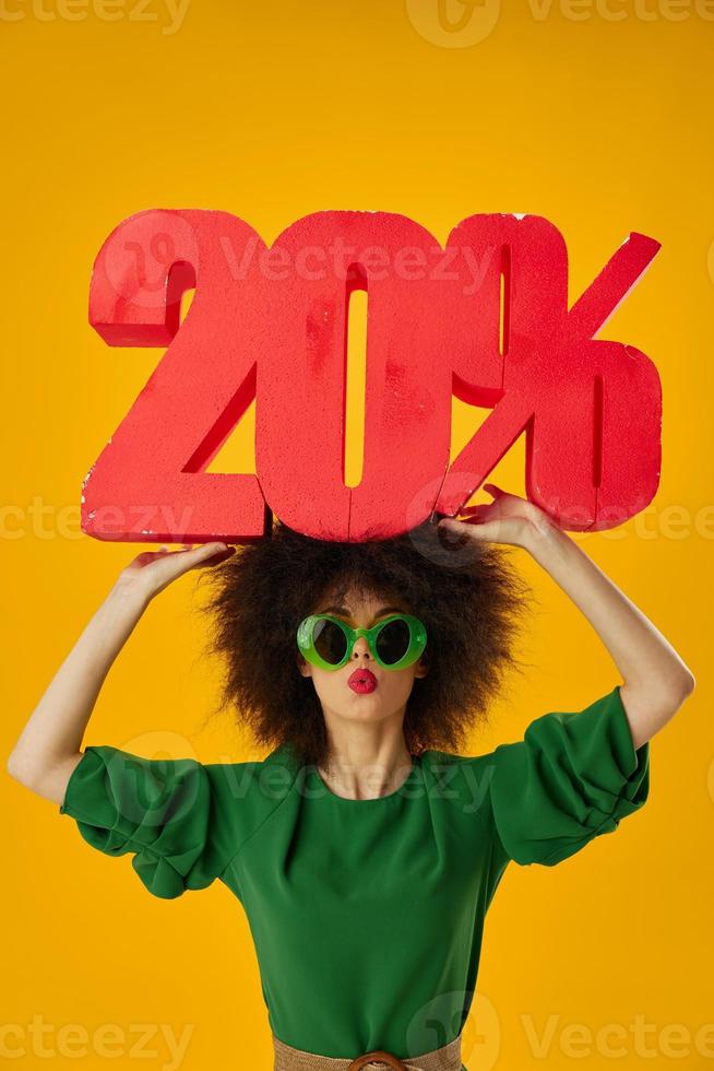 Pretty young female curly hairstyles green dress twenty percent discount yellow background unaltered photo