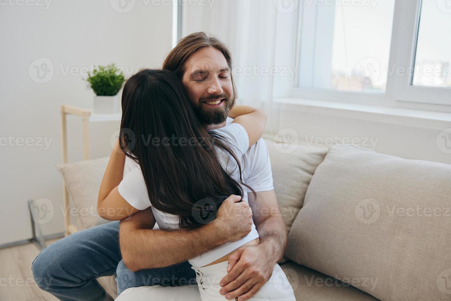 The man hugs the girl and smiles. The joy of using the family and the good psychological state after the quarrel photo