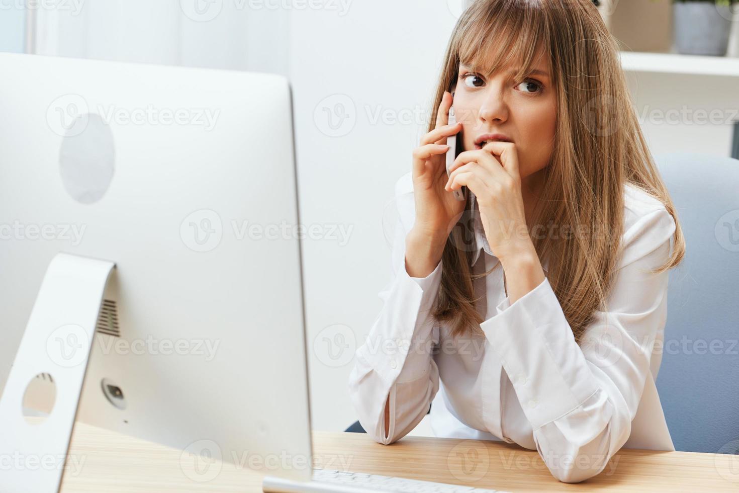 Nervous adorable blonde businesswoman worker freelancer made big mistake talking with client in call in light modern office. Unhappy employee work on computer online in support service. Copy space photo