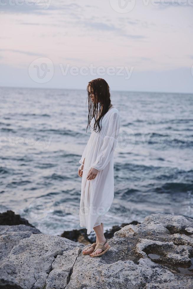 Woman stands on the shore of the ocean stones landscape nature photo