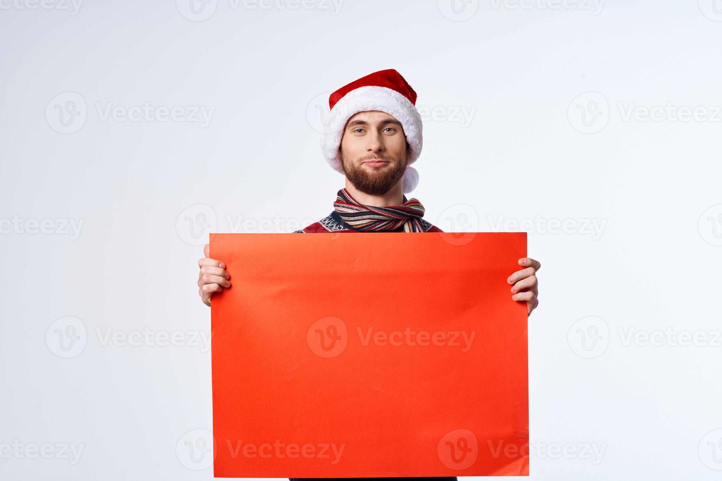 emotional man in a christmas hat with Red mockup poster light background photo