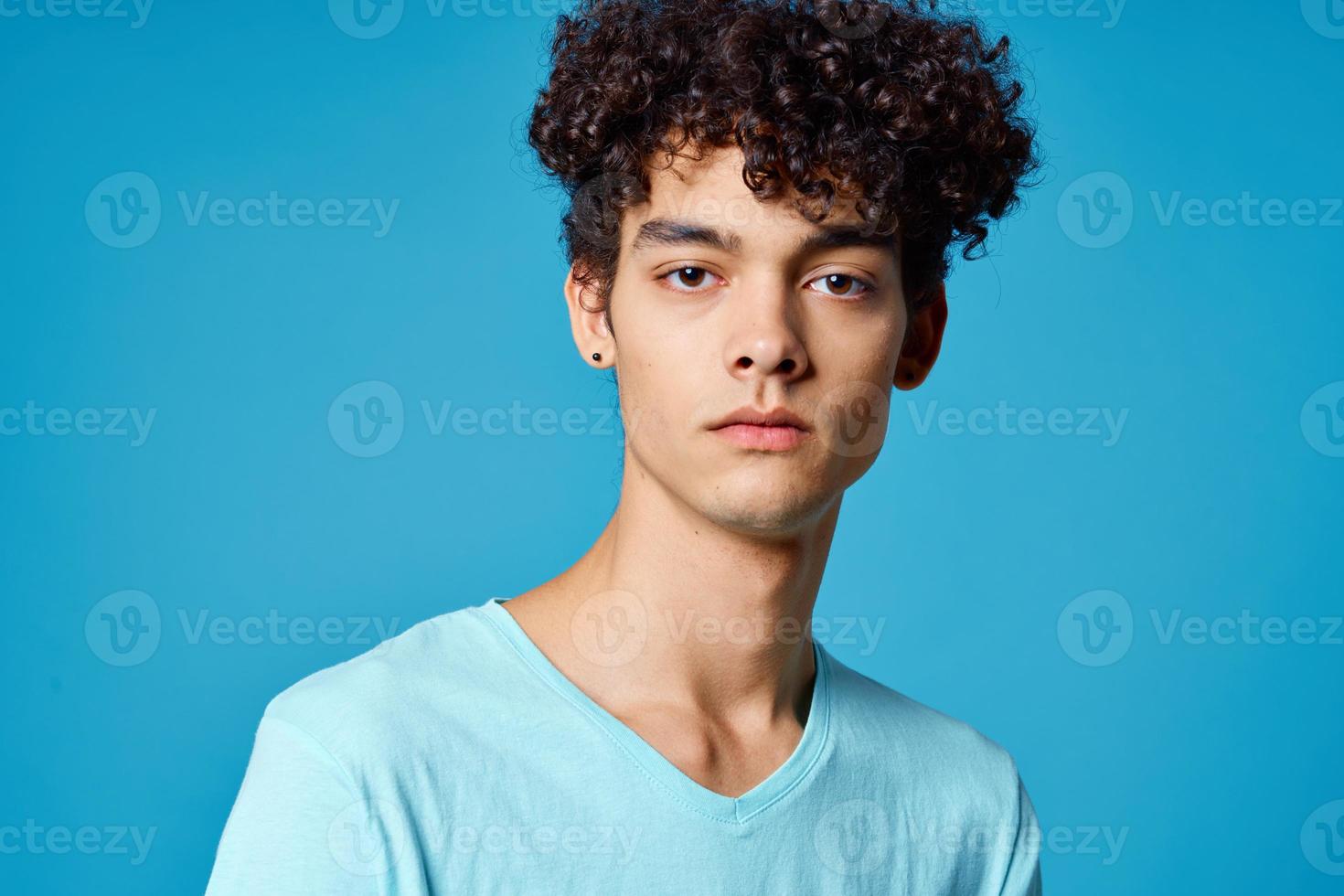 cute guy curly hair blue t-shirt isolated background photo