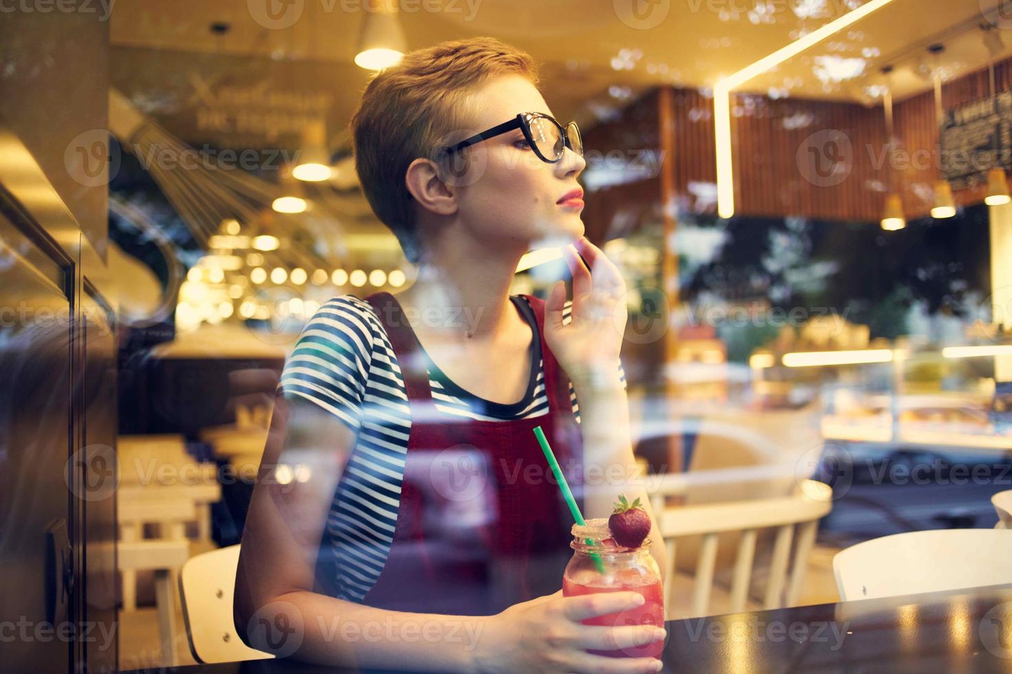woman sitting in a cafe with a cocktail one lifestyle leisure photo