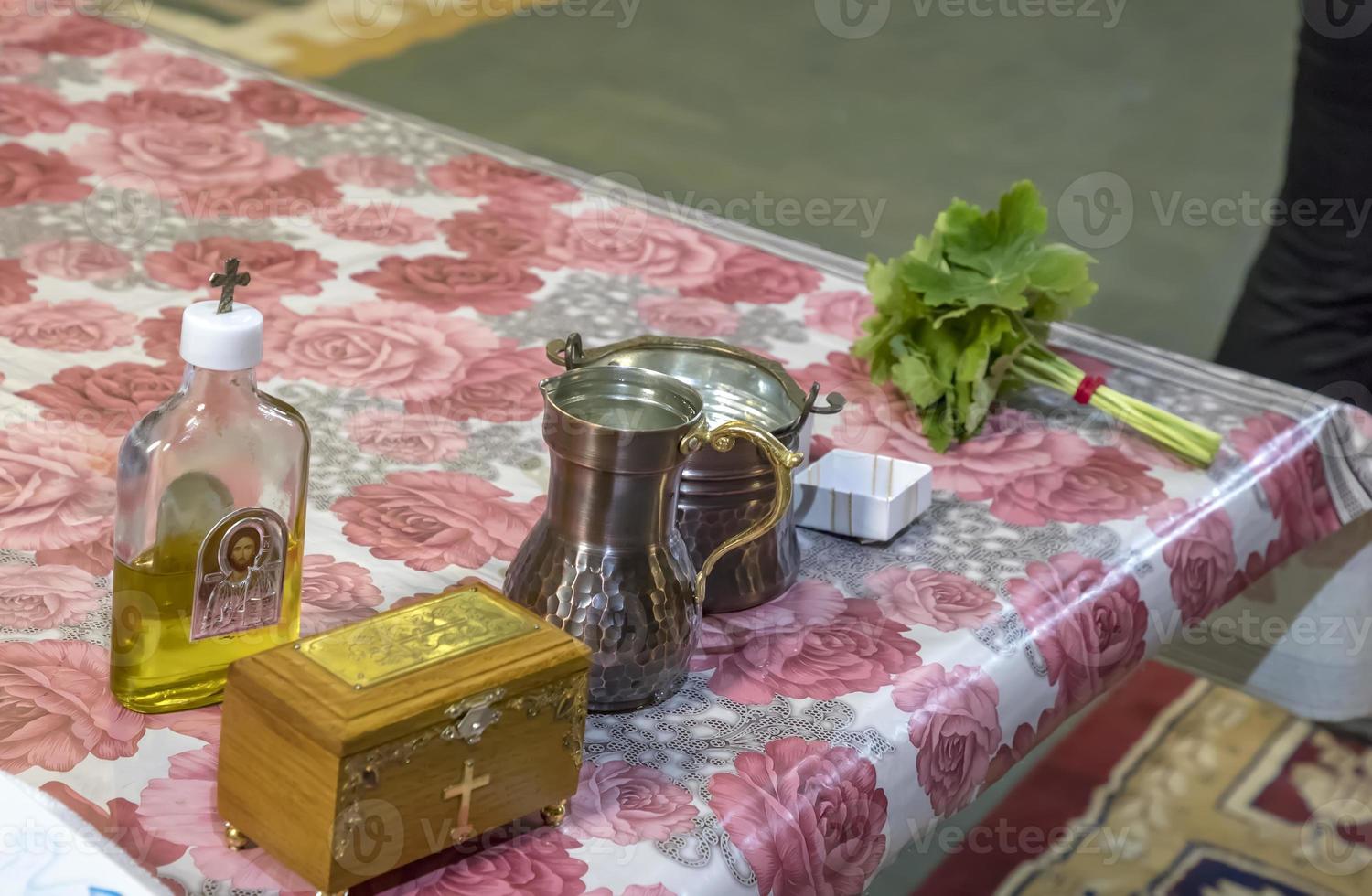 a box and the necessary accessories of a Christian priest and green geranium on the table in the church. Details in the Orthodox Christian Church photo