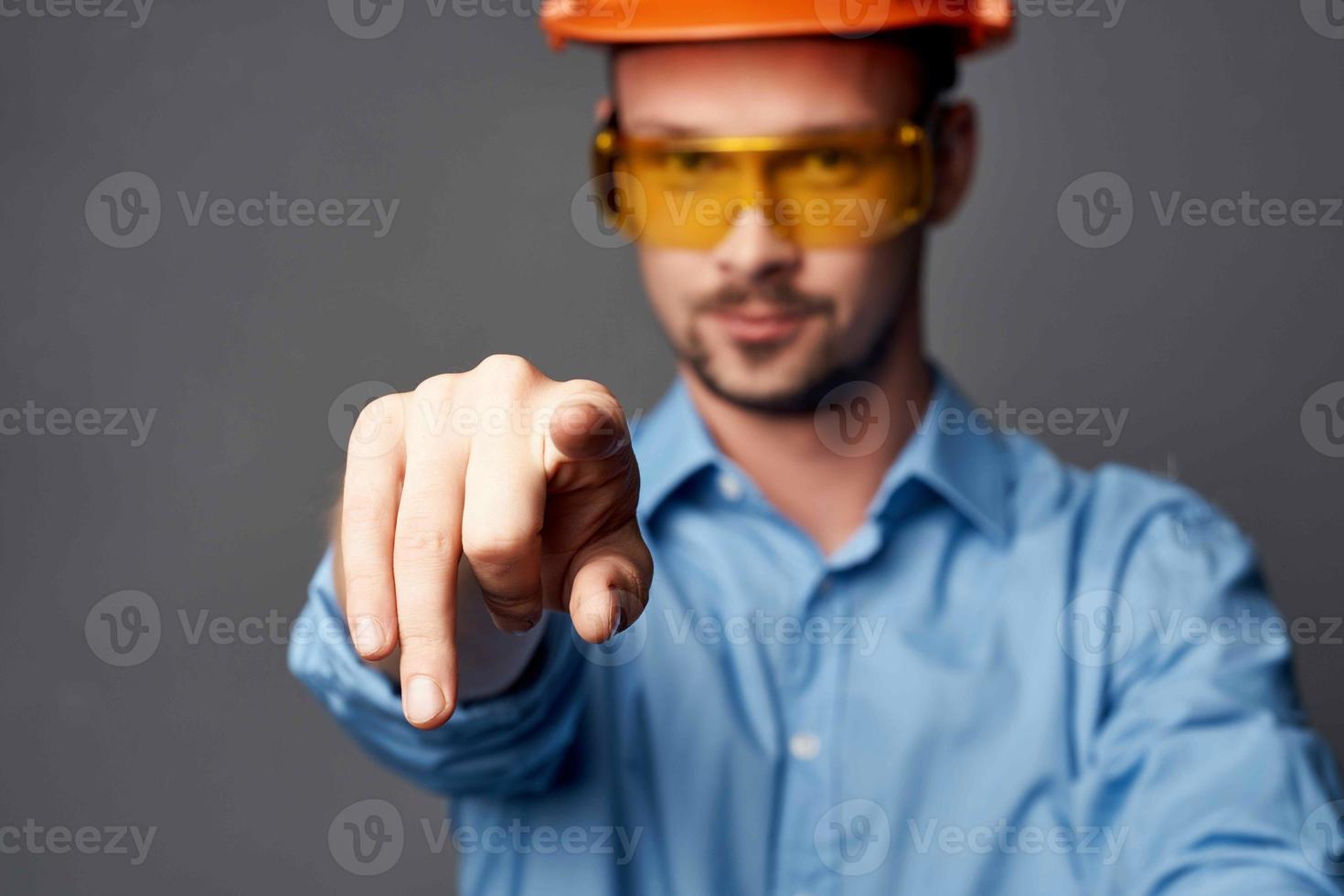 man wearing yellow glasses with orange paint safety work service photo