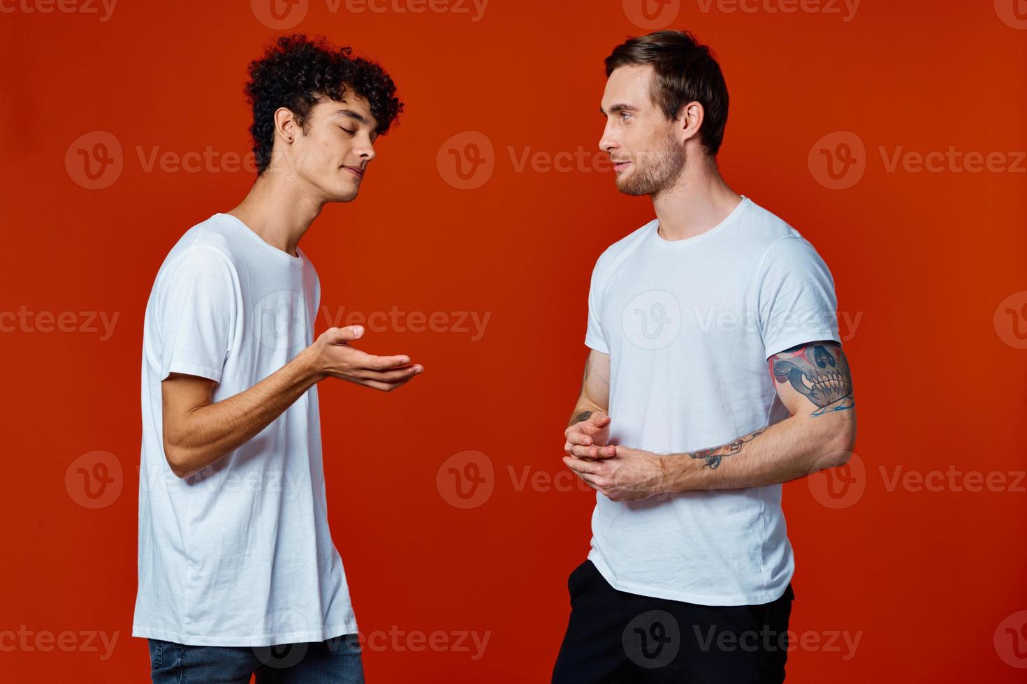 dos alegre amigos en blanco camisetas comunicación aislado antecedentes divertido foto