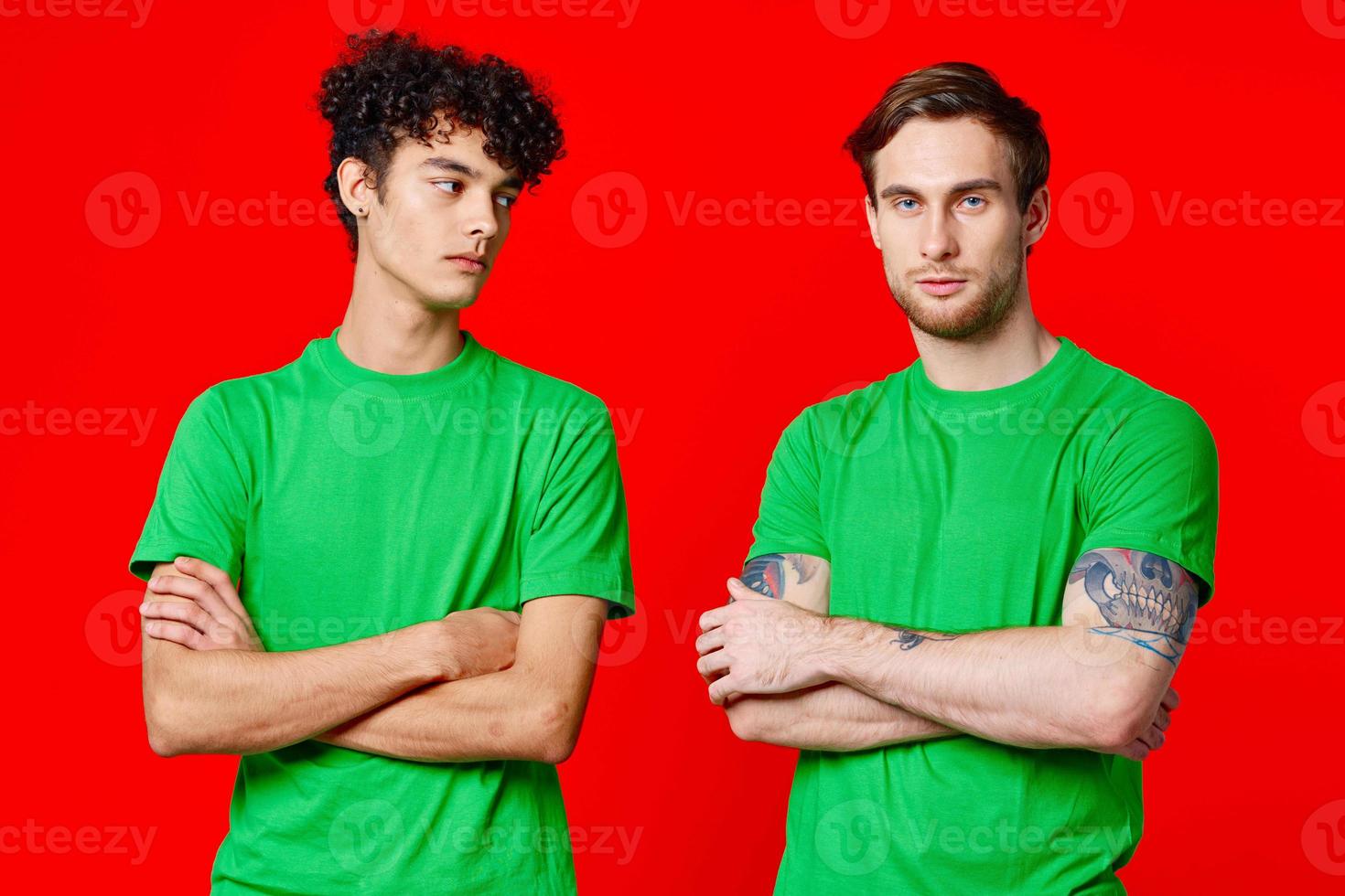 two friends green t-shirts communication lifestyle red background photo
