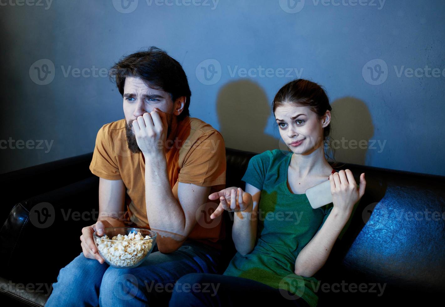 evening tv watching and a married couple with popcorn in a plate photo