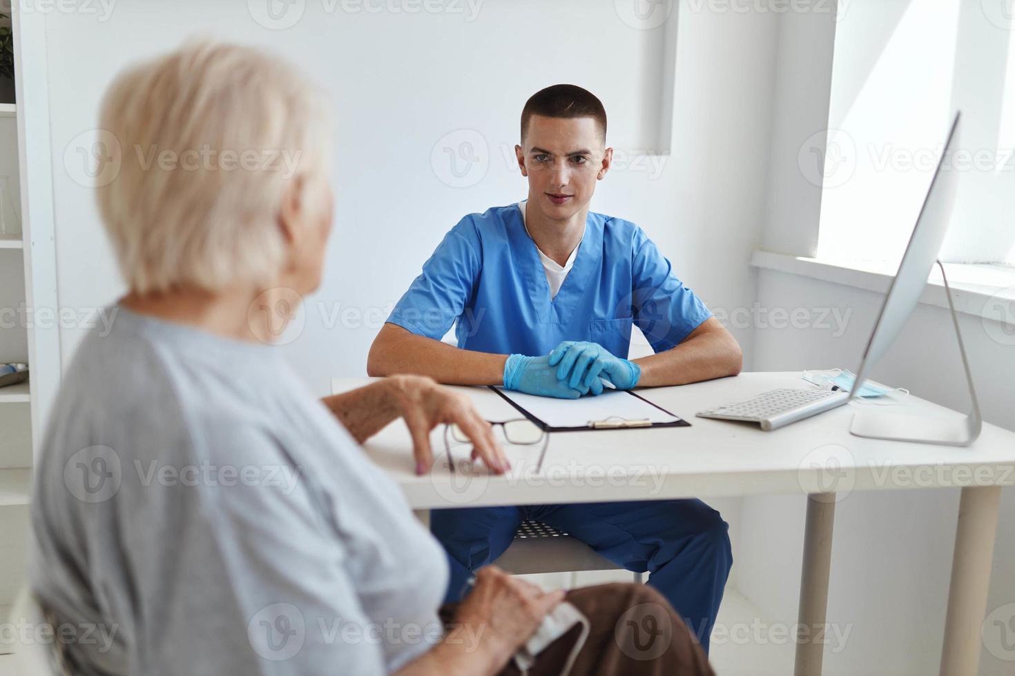 elderly woman patient talking to doctor health care photo