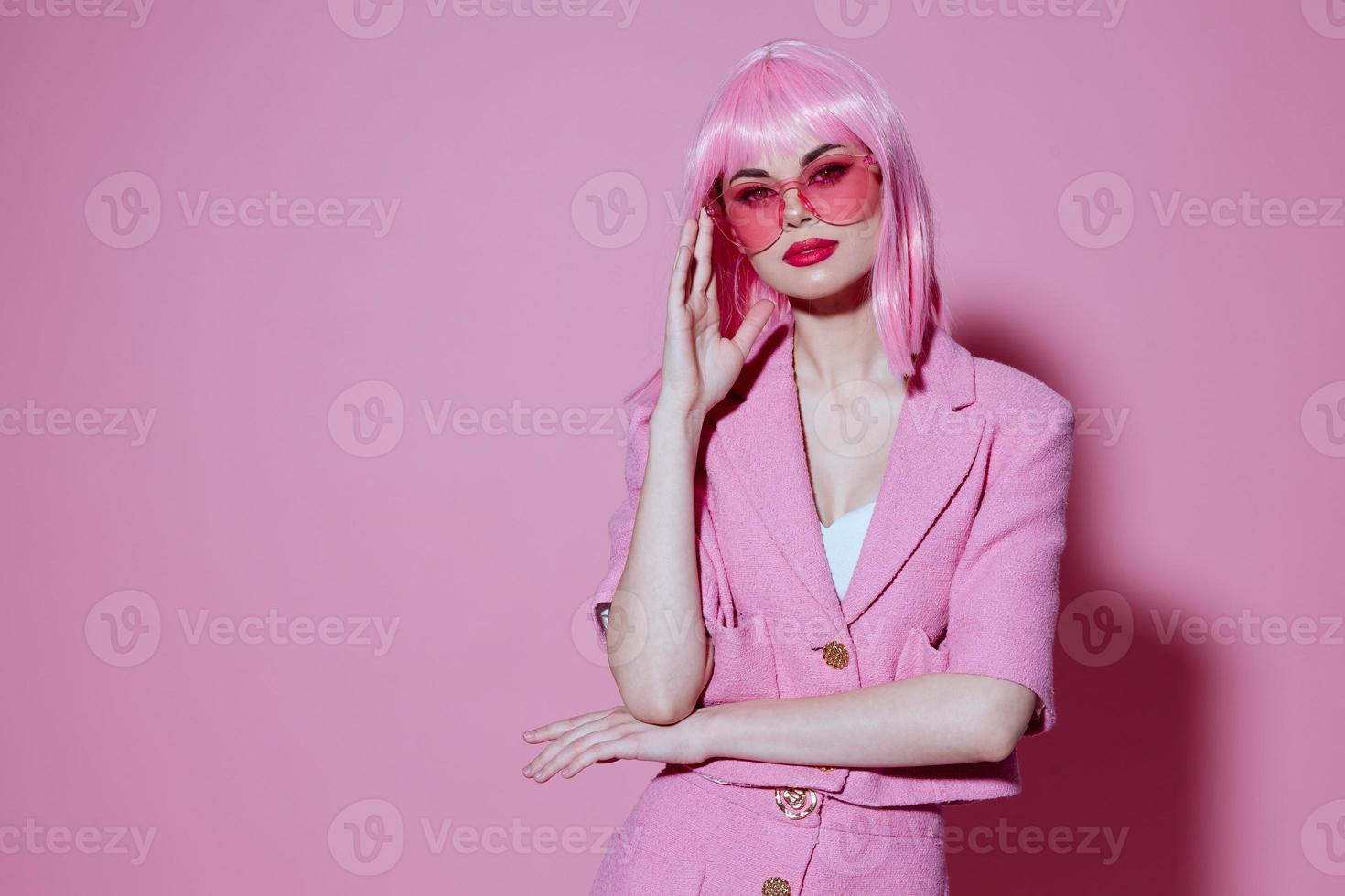 Portrait of a charming lady in pink glasses cosmetics glamor emotions color background unaltered photo