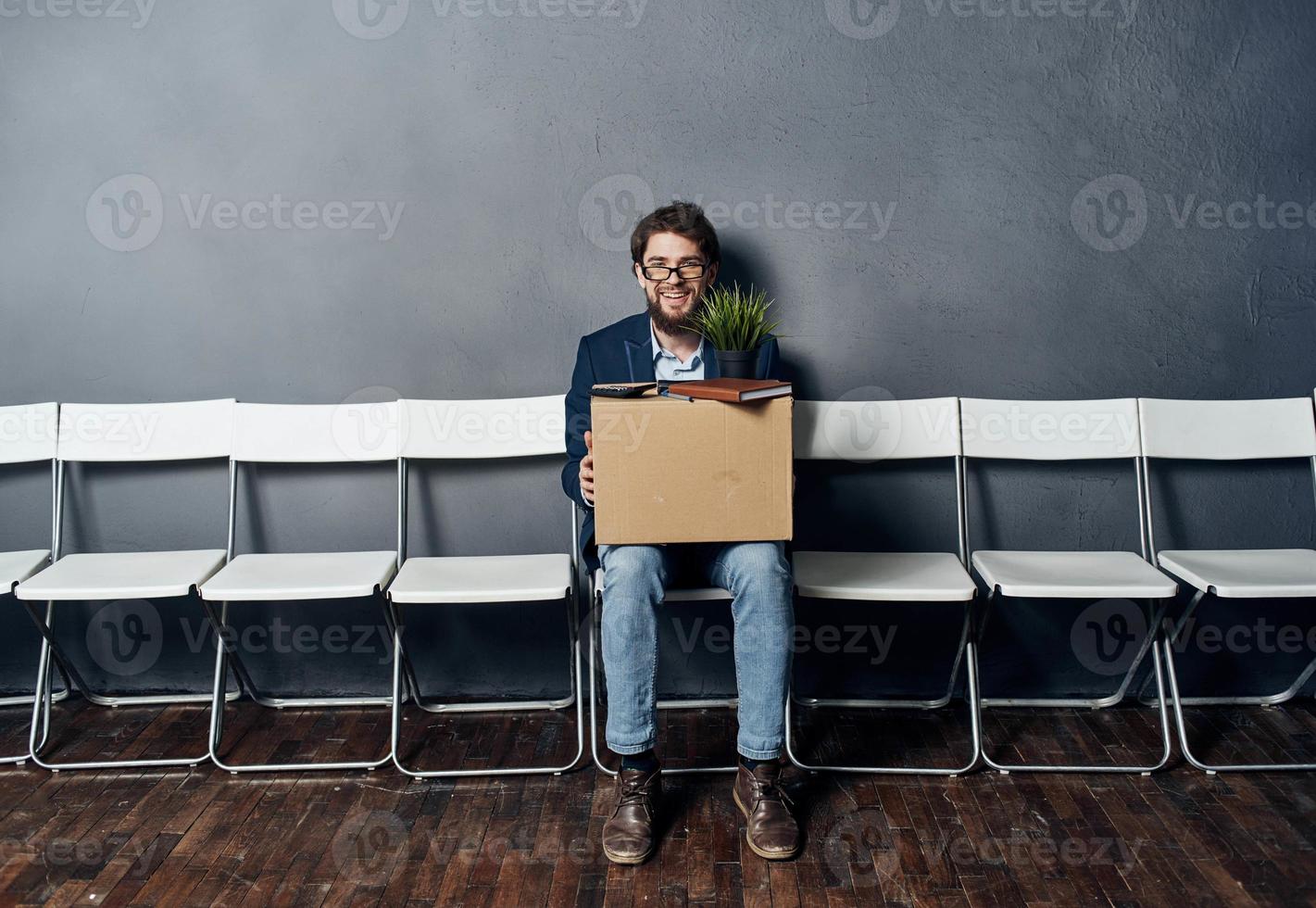 Man sits on a chair box with things dismissing discontent depression photo