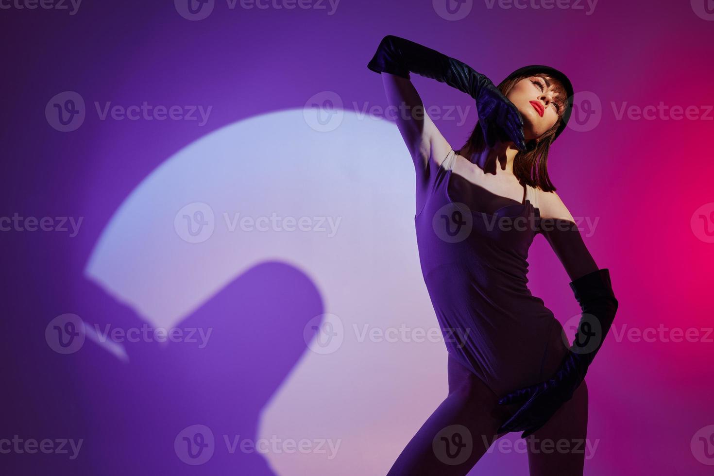 Beautiful fashionable girl scene spotlight posing neon purple background unaltered photo