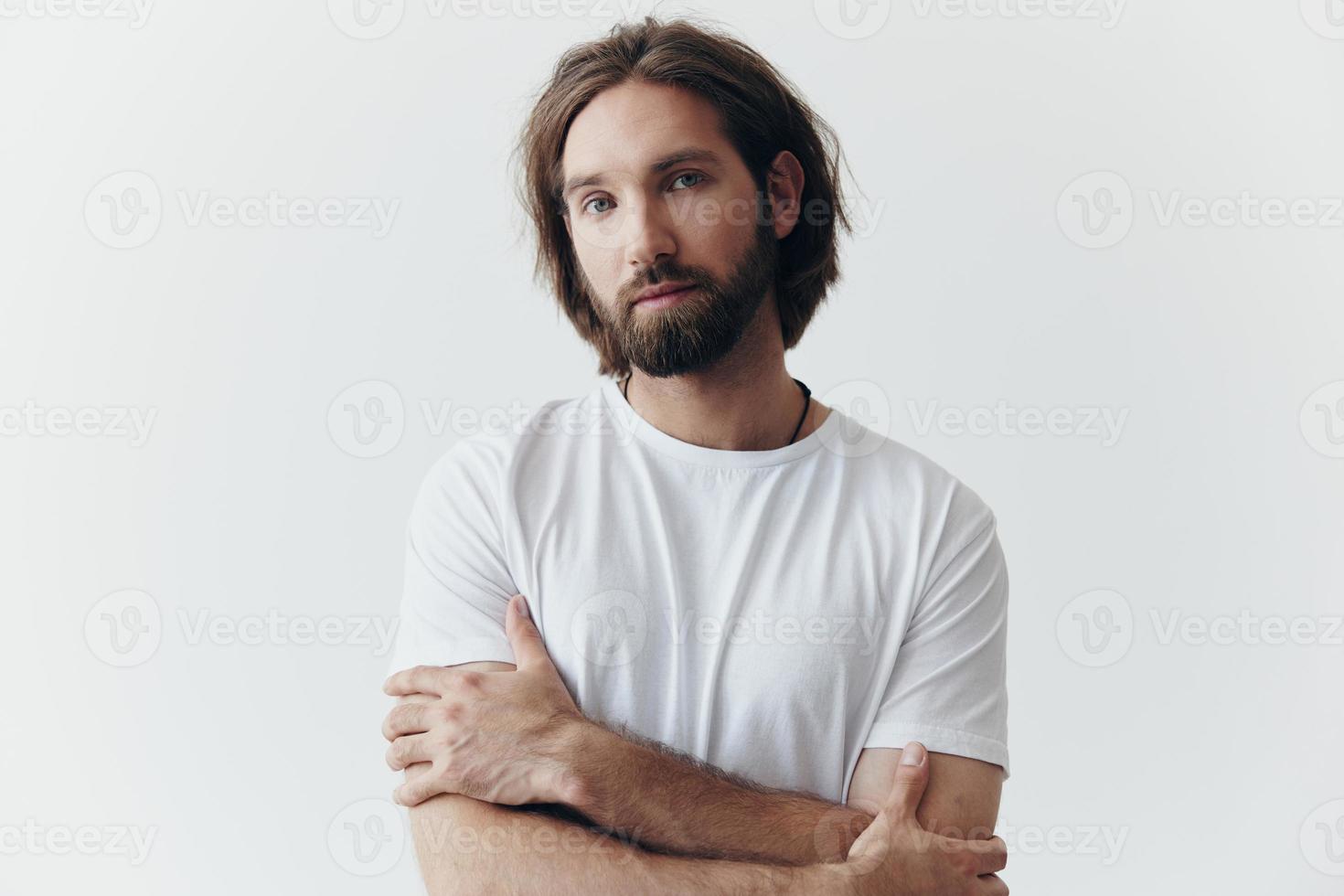 retrato de un hombre con un negro grueso barba y largo pelo en un blanco camiseta en un blanco aislado antecedentes estilo de vida sin patetismo todos los días imagen foto