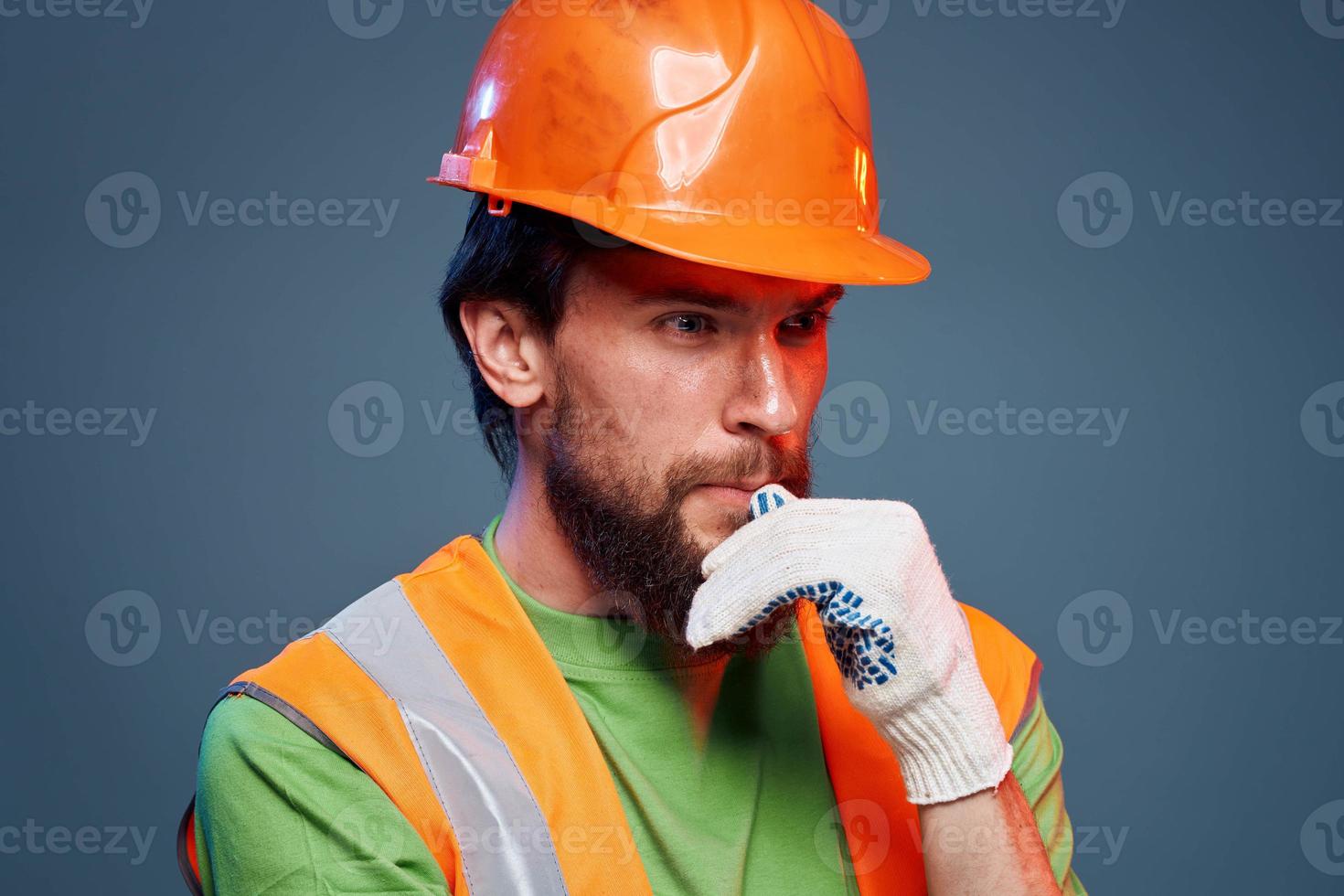 Man in work uniform orange paint safety work fatigue blue background photo