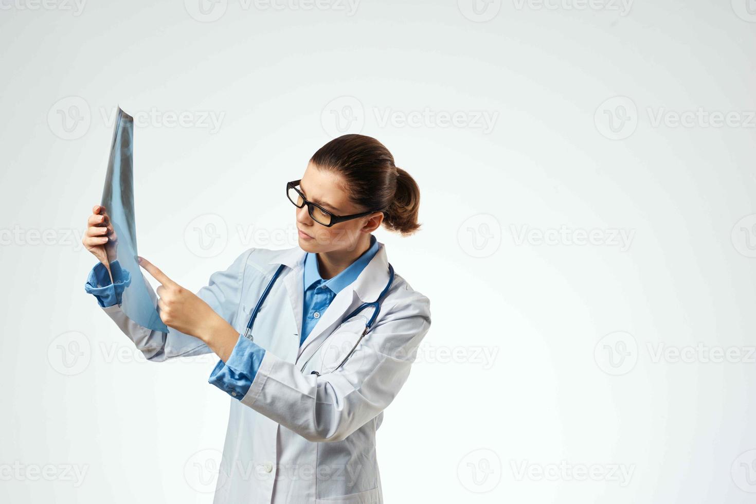 woman doctor radiologist x-rays examination hospital light background photo