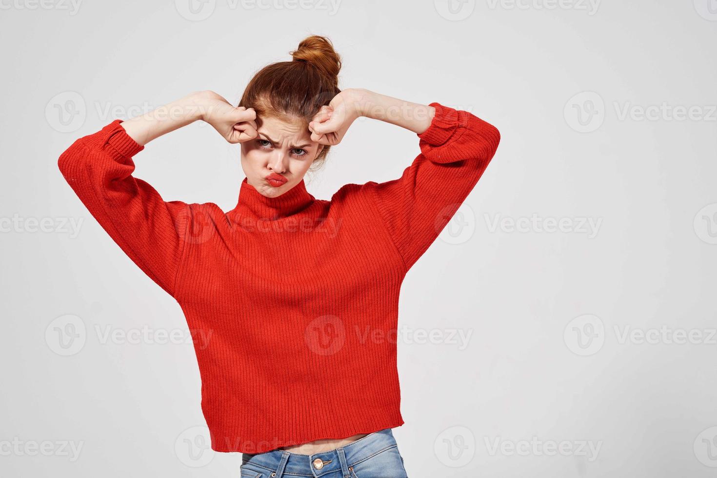 pretty woman in a red sweater light background photo