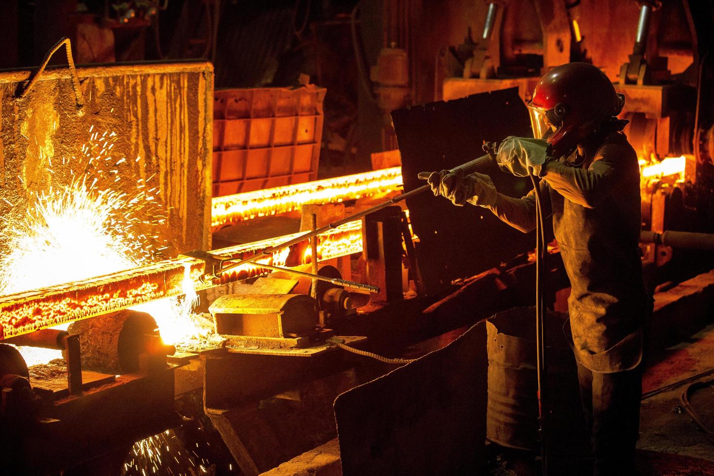 Bangladesh May 19, 2015 Workers melt metal scraps in the furnace of a steel mill to produce rods in Demra, Dhaka, Bangladesh. photo