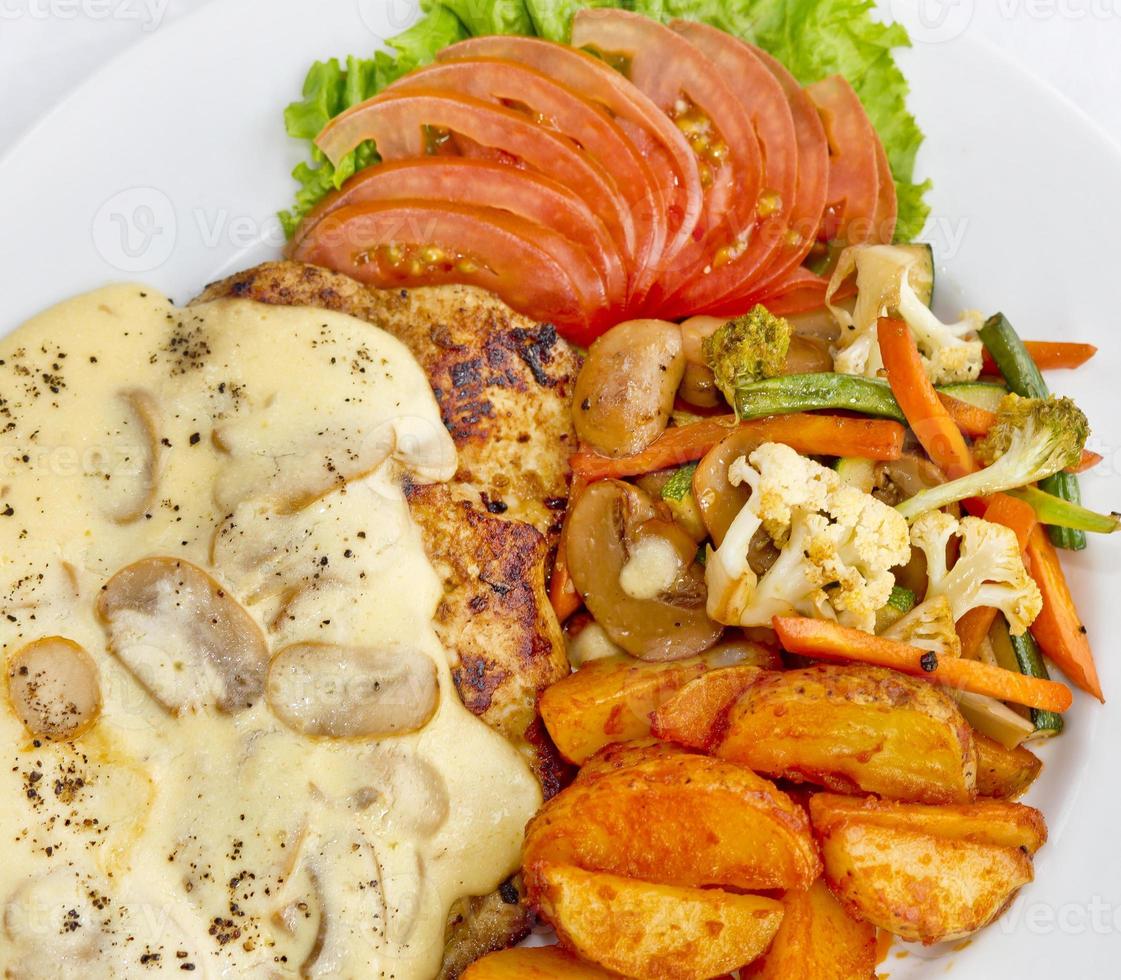 Peri peri Chicken with Button mushroom gravy, Saute Vegetables, Spicy fried Potatoes with Tomato Lettuce Salad. photo