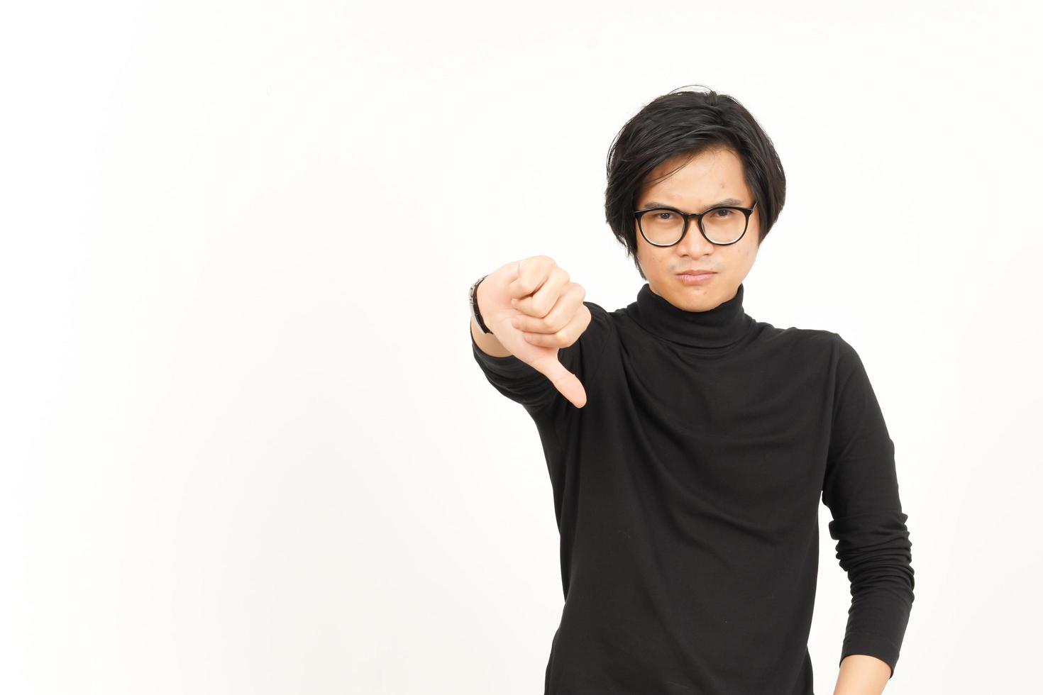 Showing Thumbs Down Of Handsome Asian Man Isolated On White Background photo