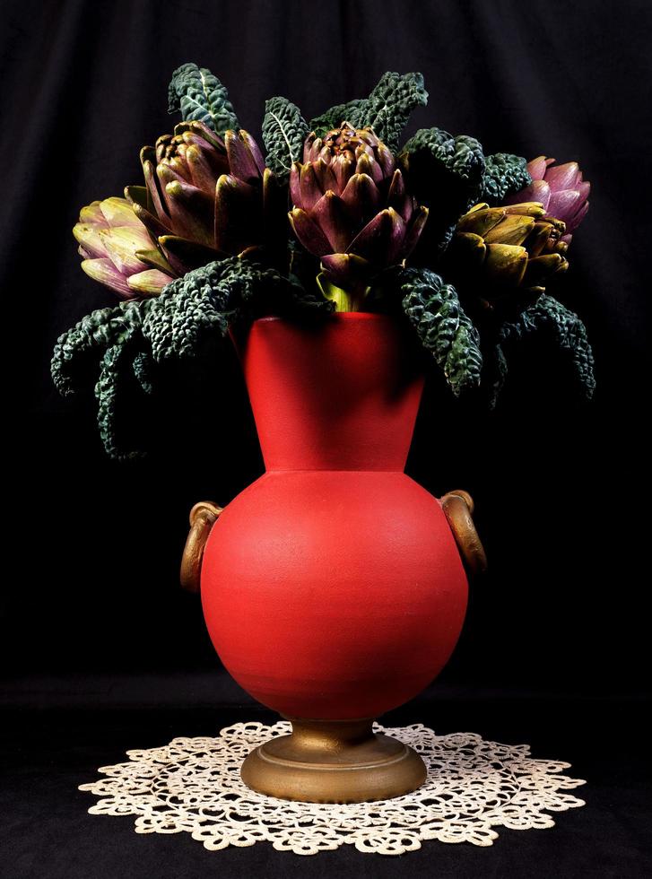 Cervia, Ravenna province, Italy March 04, 2023. Still life composition in artificial light of pot with artichokes and black cabbage. photo