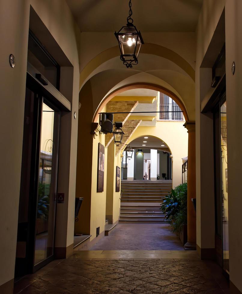 Bologna, Italy, June 2, 2022 Corte Isolani. Suggestive street passage with restaurants and shops that connects two of the main arteries of the historic center of Bologna. photo